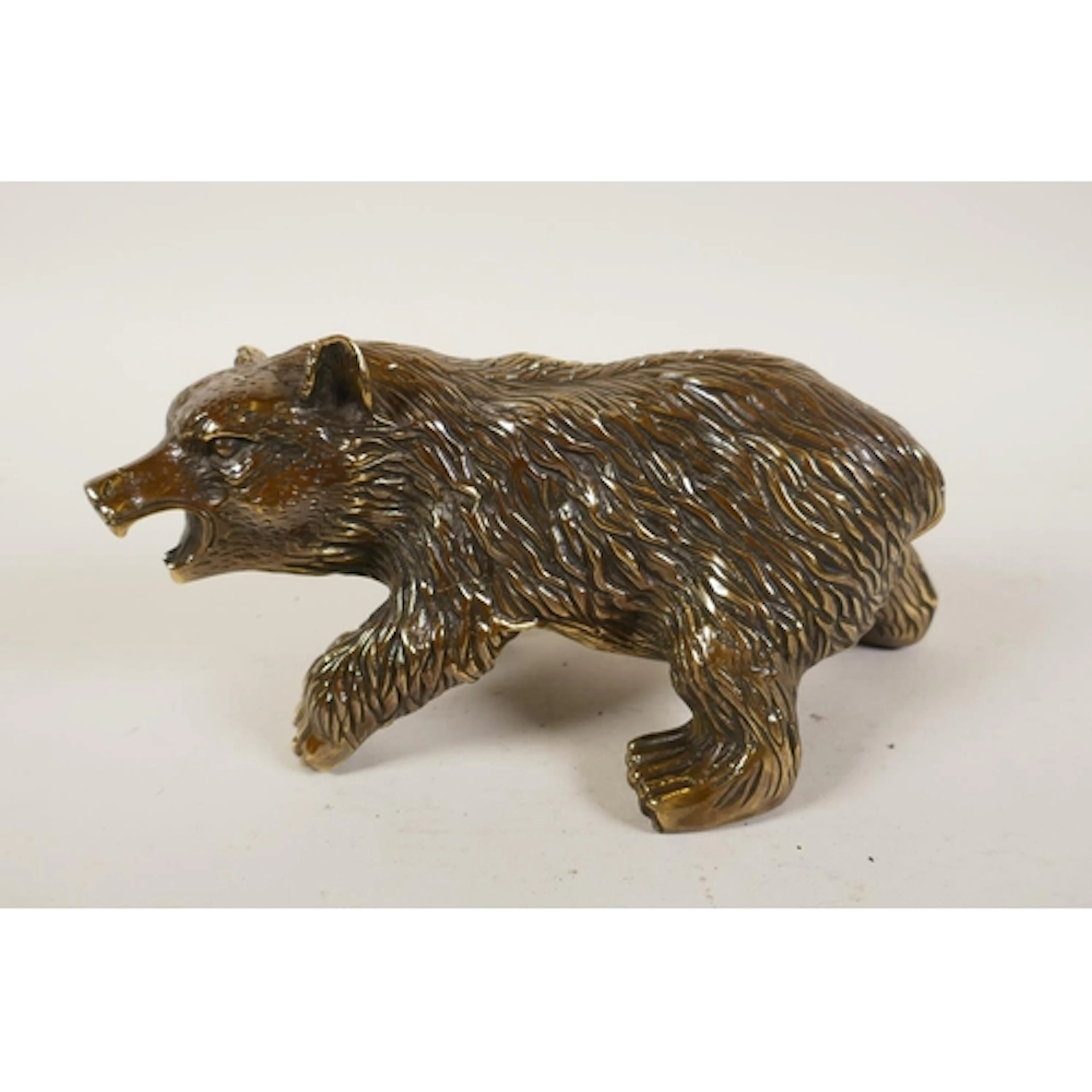 A filled brass bear, 21cm long