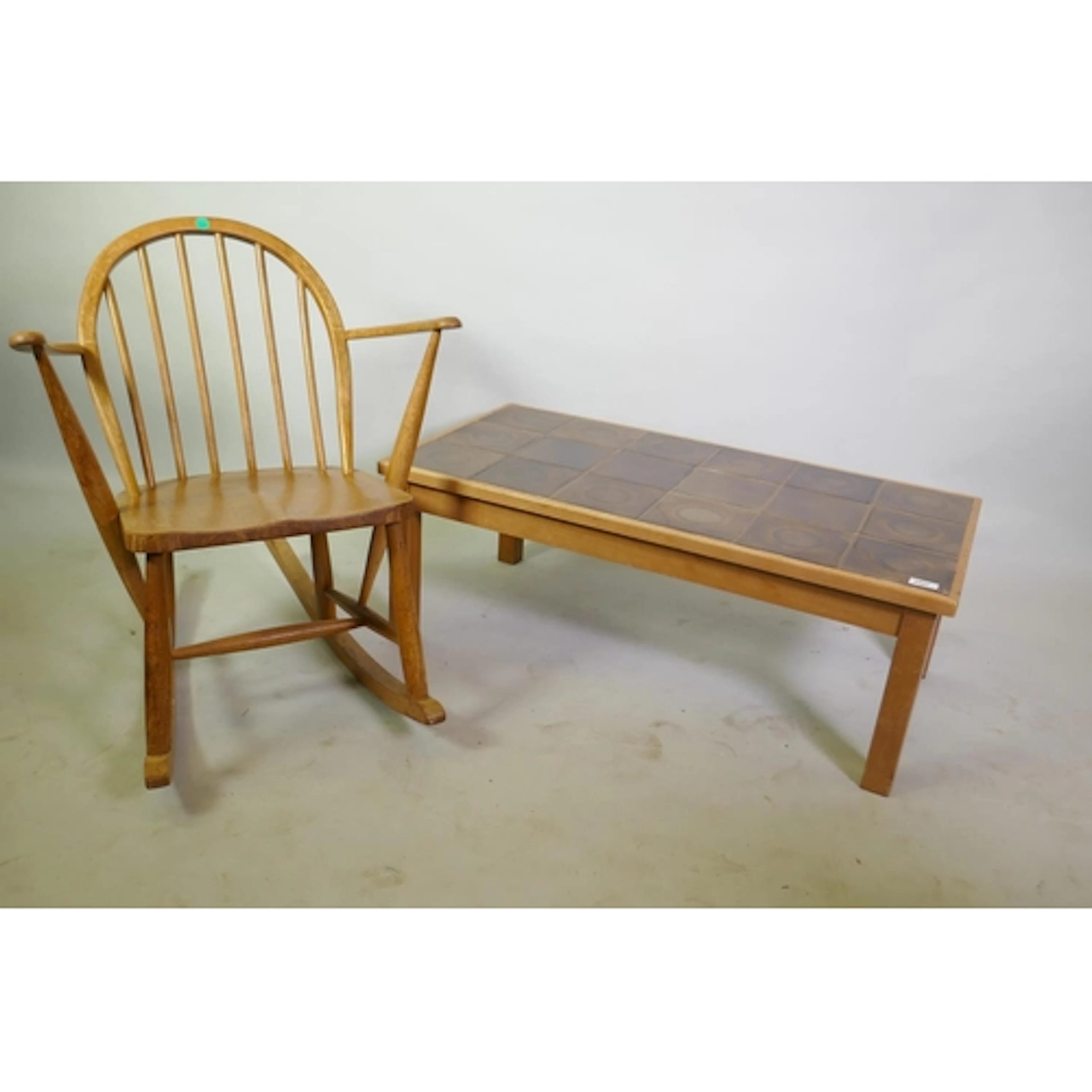 A mid century Ercol blond elm stick back rocking chair of sm...