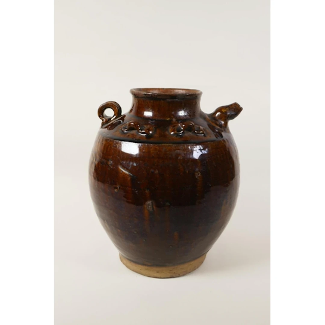 A Chinese treacle glazed pottery water pourer, 26cm high