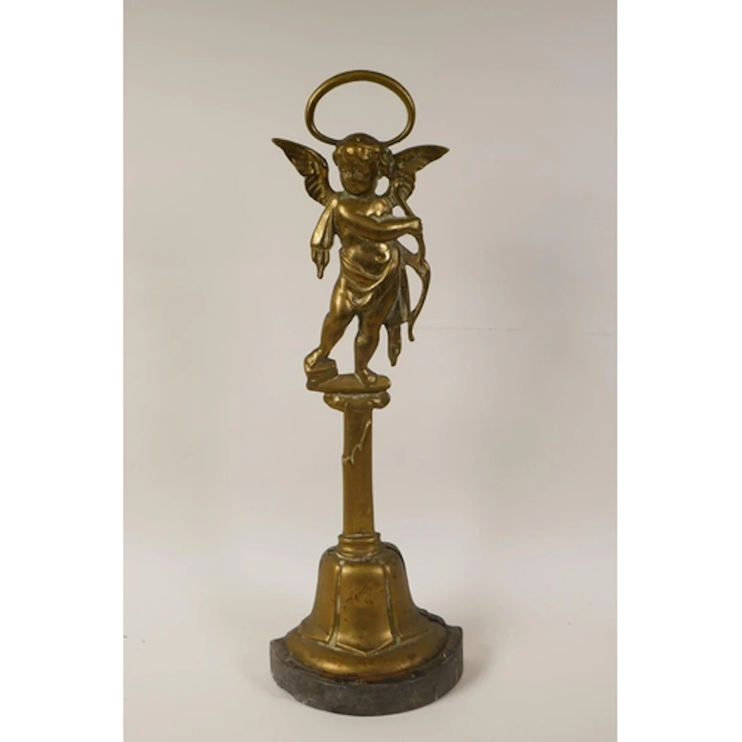An antique brass and iron door stop/door porter in the form ...