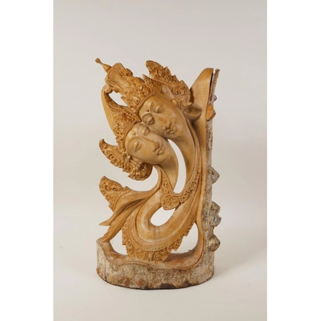 A Balinese wood carving of stylised couple, inscribed LAMA t...