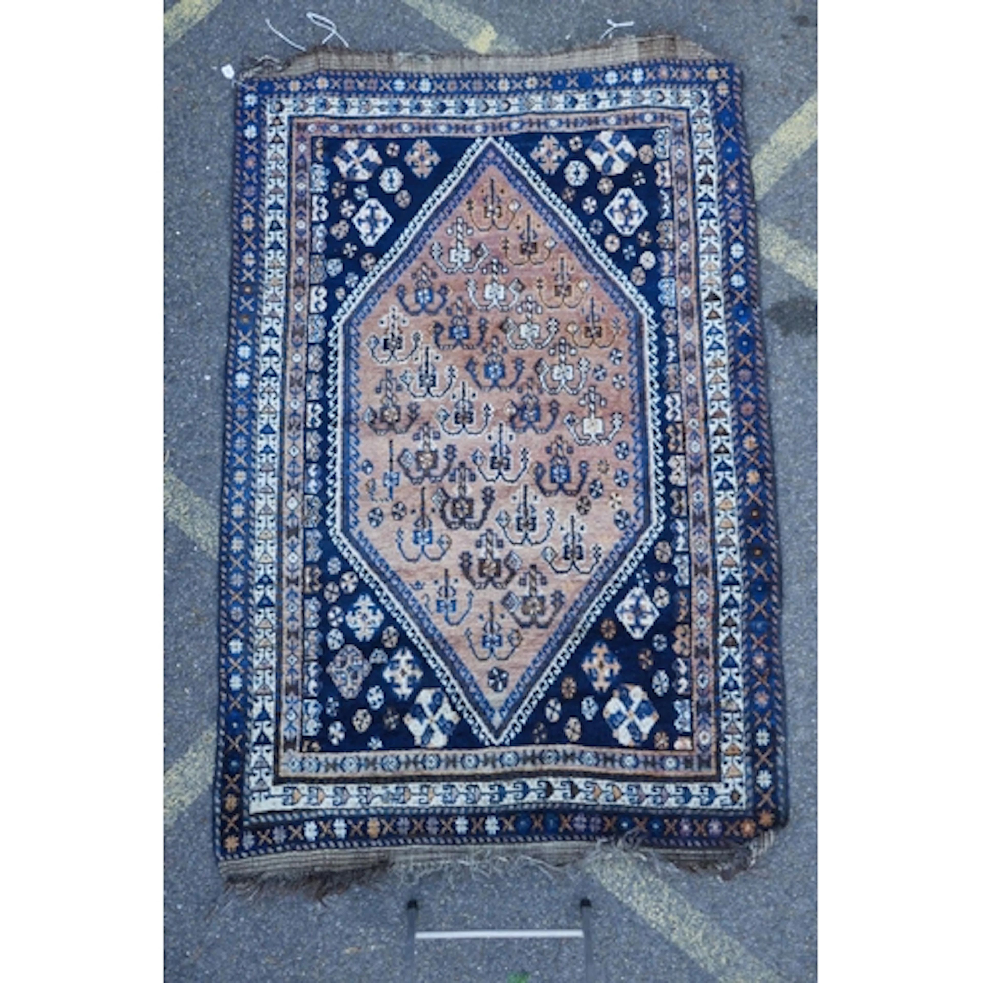 A Persian faded red and blue ground wool Qashqai carpet, wit...