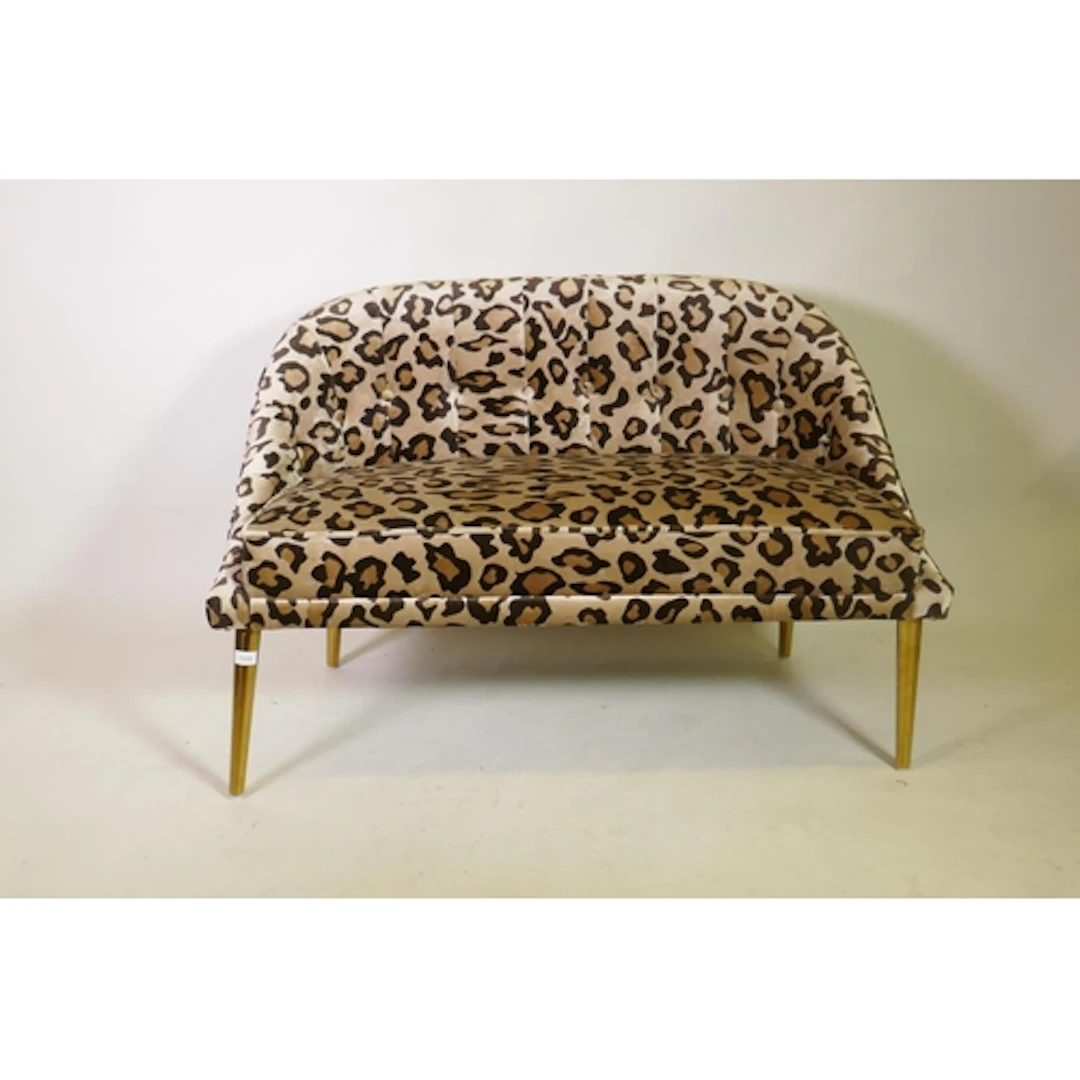 A contemporary small two seater settee with buttoned back an...