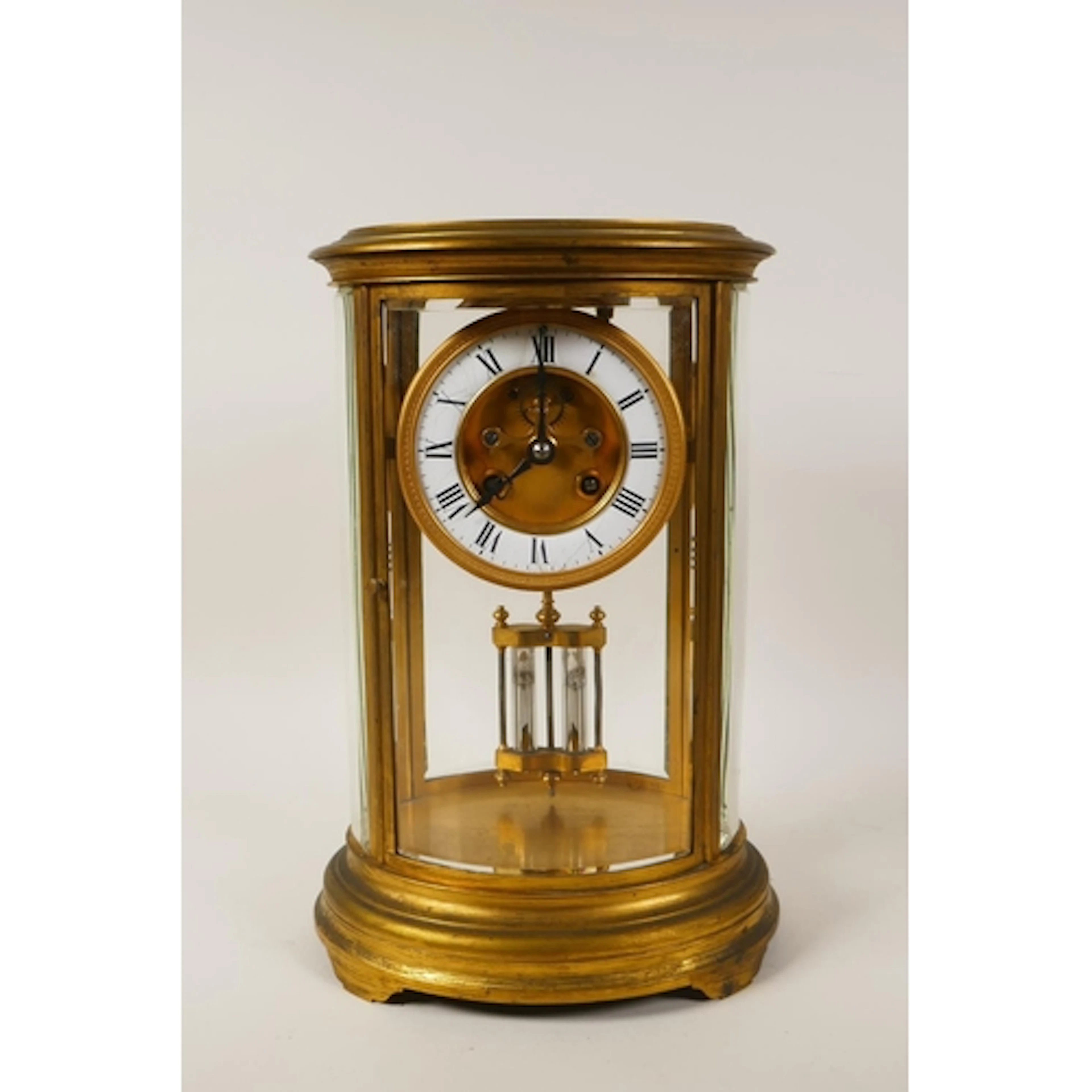 An antique French oval gilt brass four glass mantel clock, w...