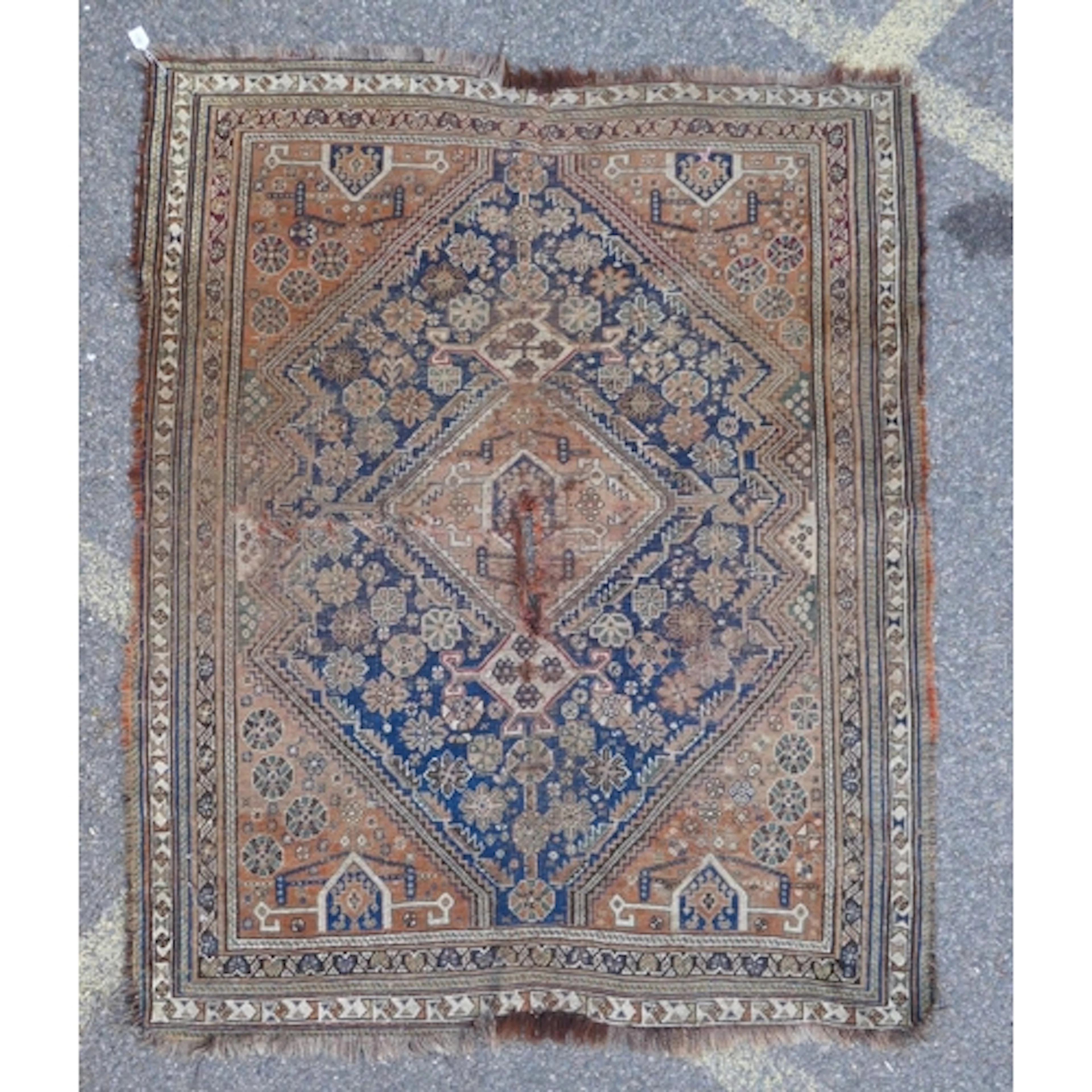 A Persian antique hand-knotted wool tribal rug, with a blue ...