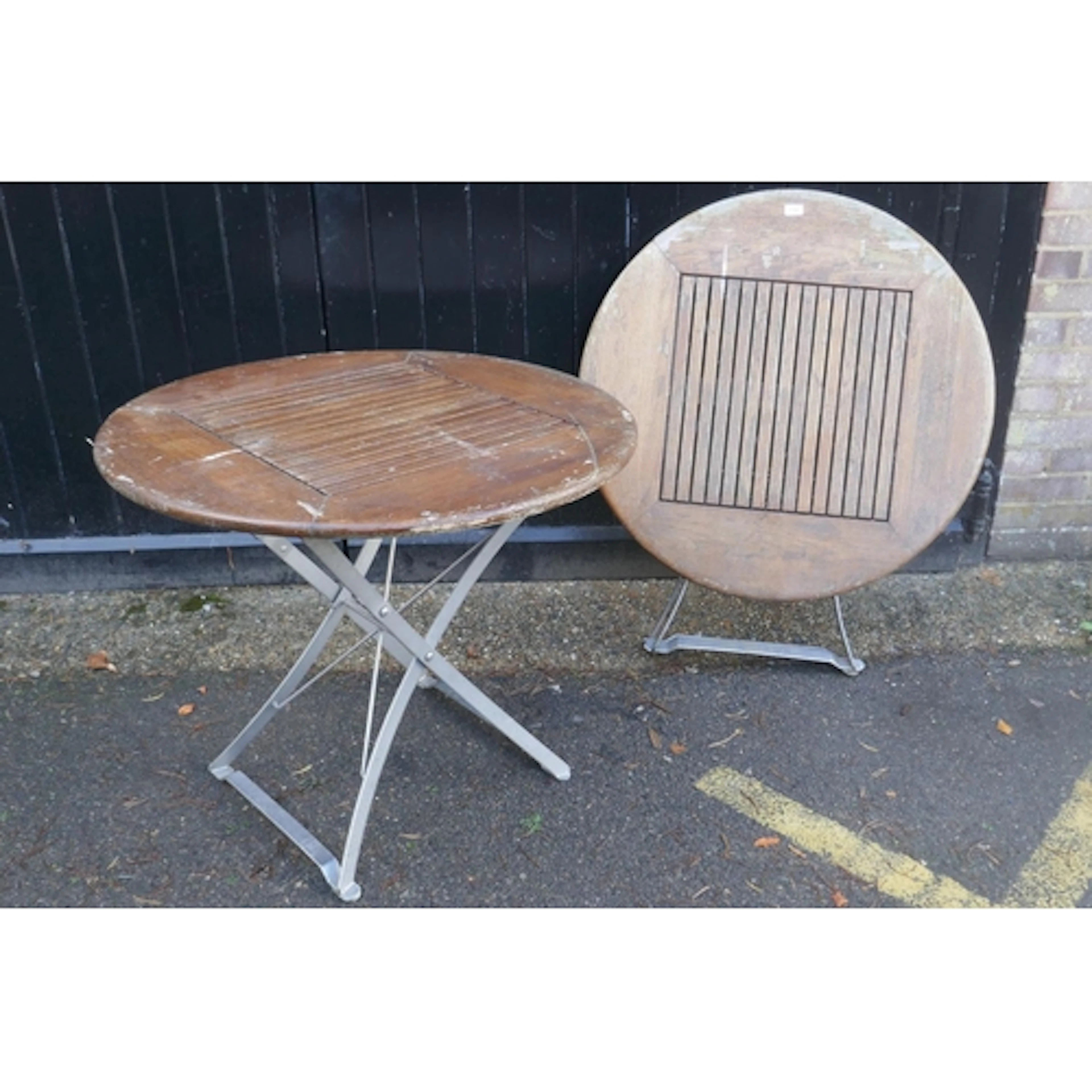 A pair of 'Lister' garden tables with slatted teak tops and ...