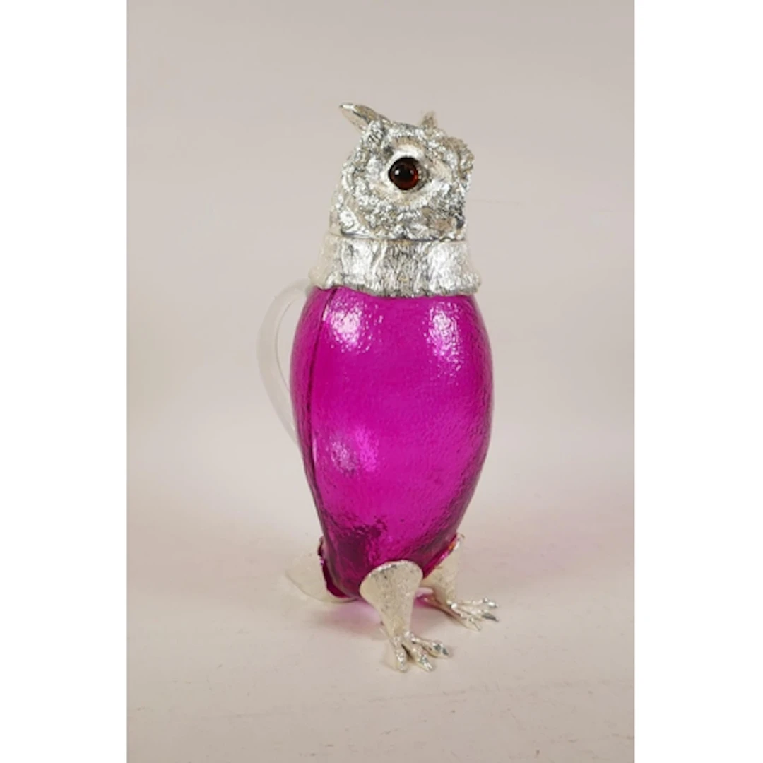 A silver plated and pink glass claret jug in the form of an ...