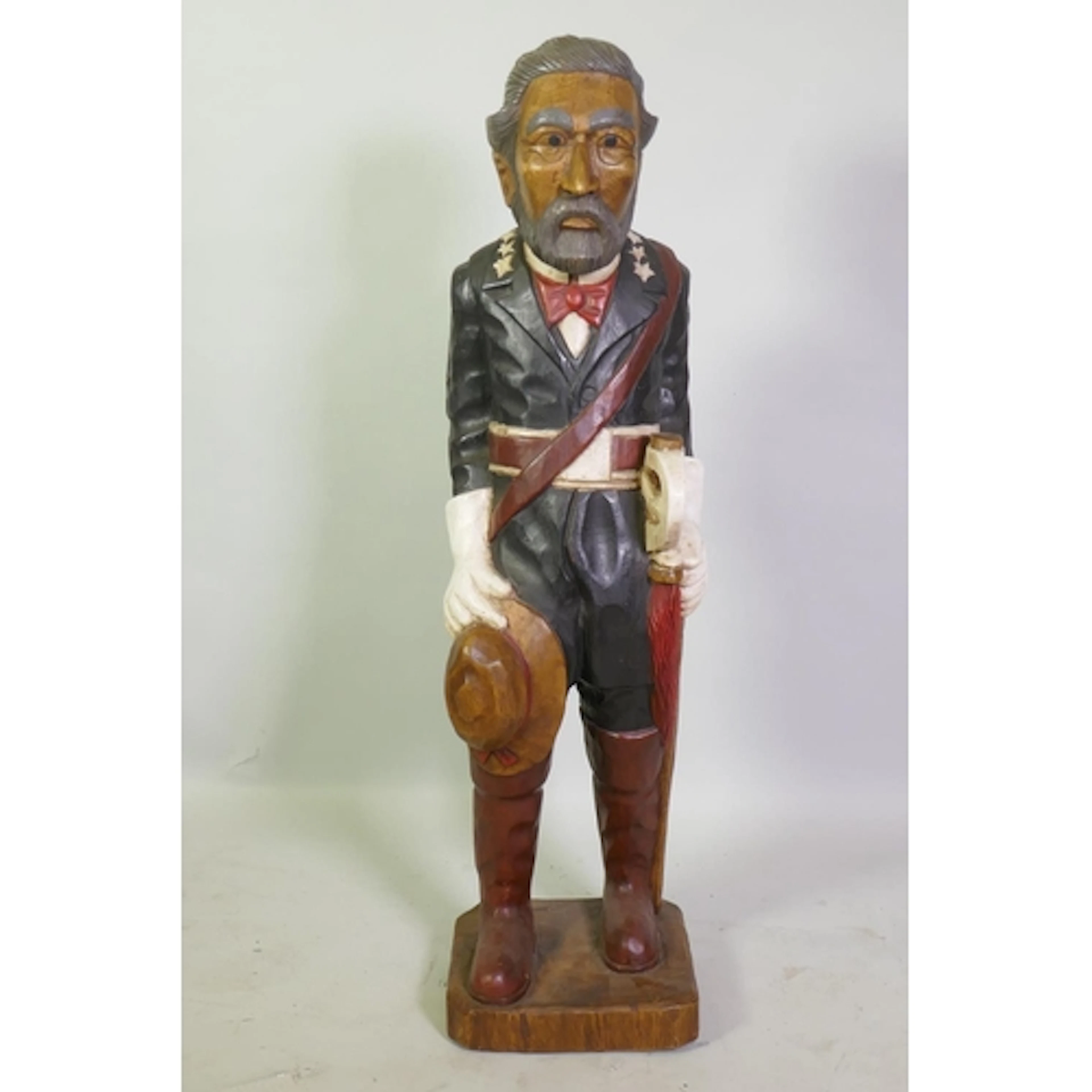 A folk art carved and painted wood figure of a Latin America...