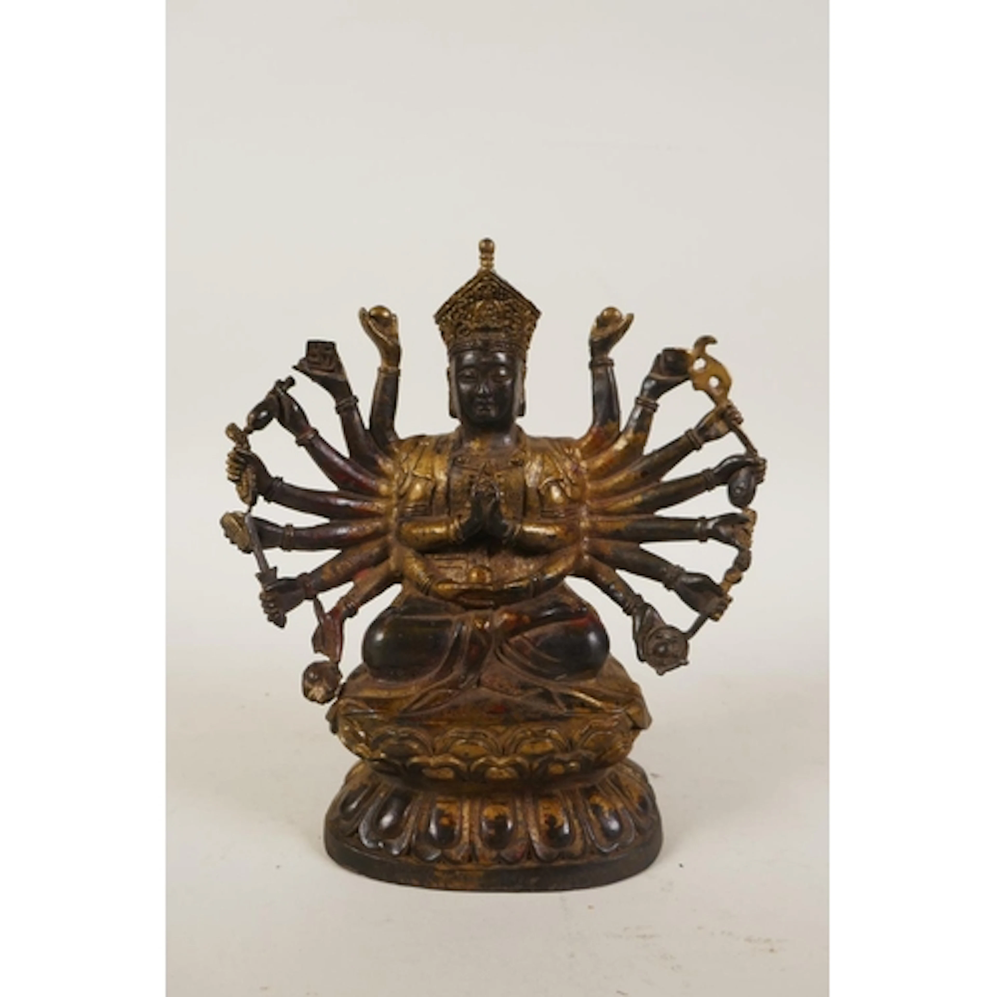 A Sino Tibetan gilt bronze multi armed deity, 18cm high
