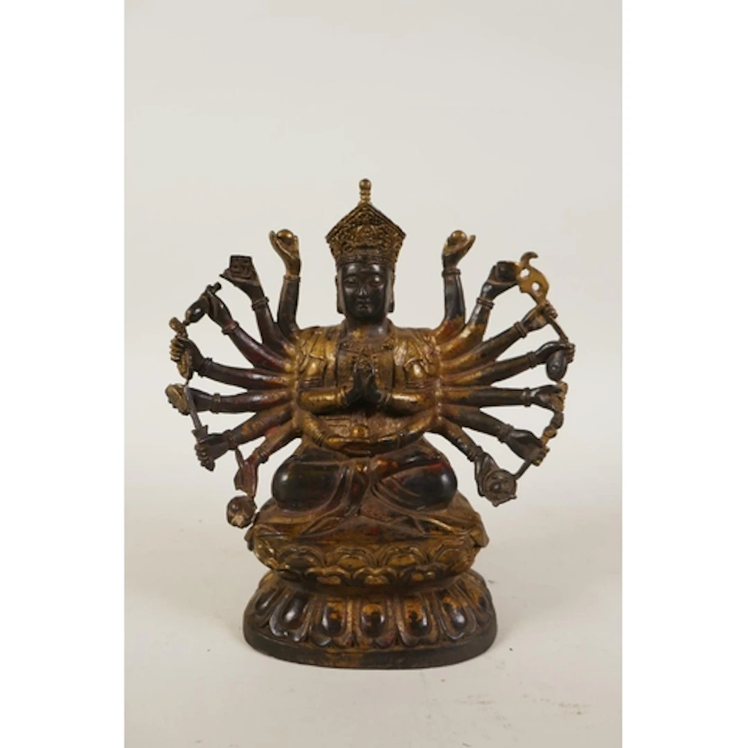 A Sino Tibetan gilt bronze multi armed deity, 18cm high