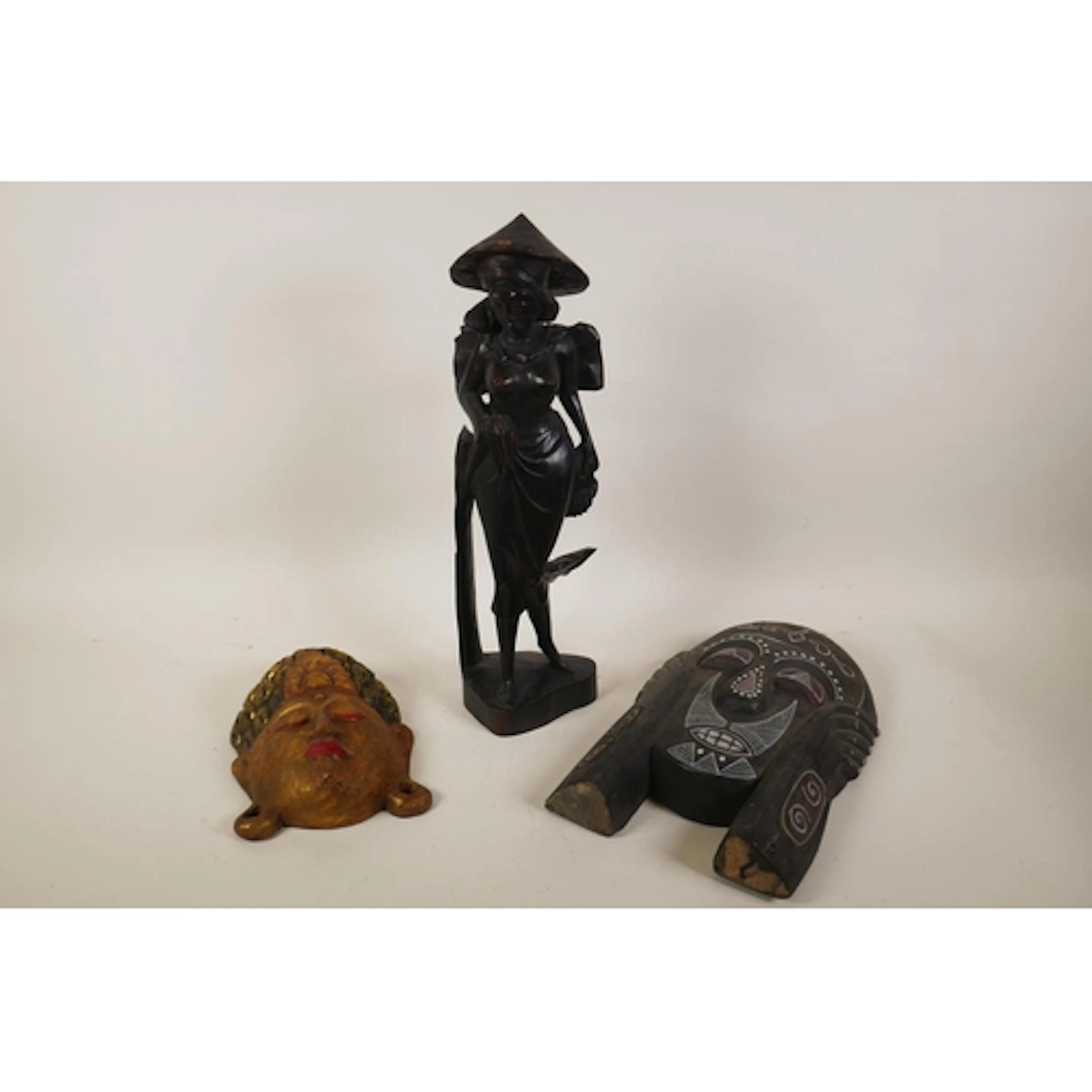 A Balinese carved hardwood female figure, a carved and gilt ...