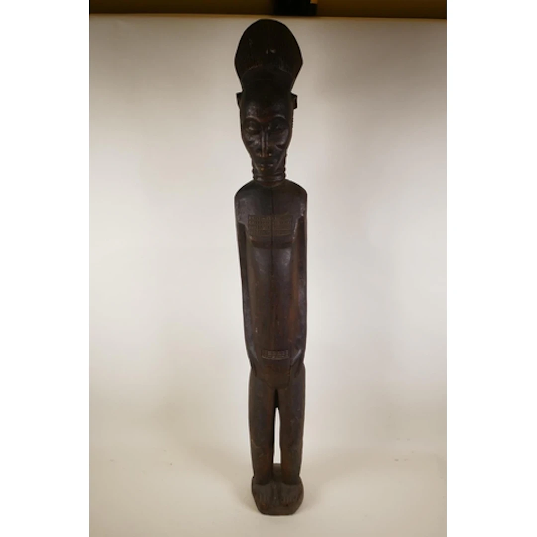 A West African carved wood floor standing figure, 100cm high