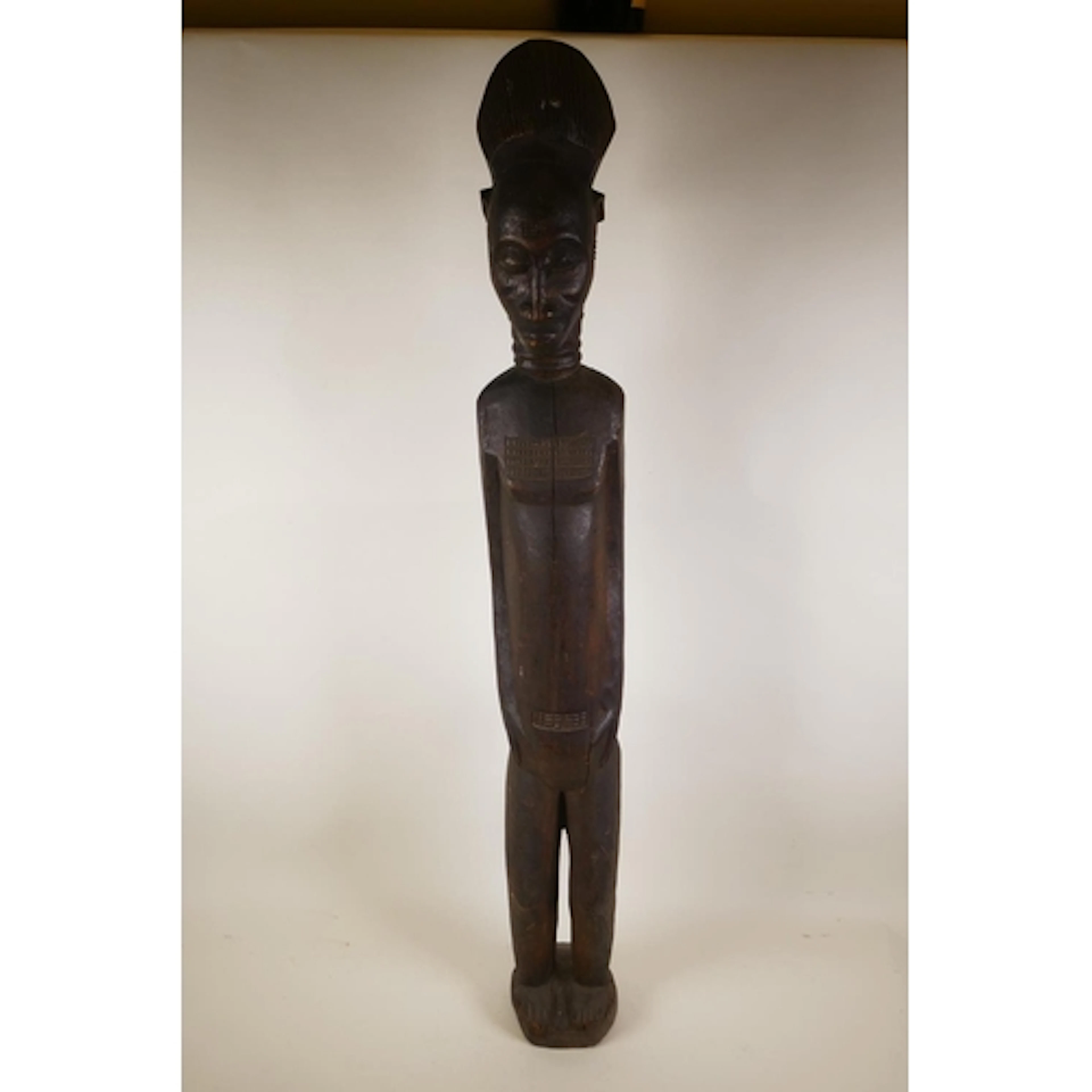 A West African carved wood floor standing figure, 100cm high