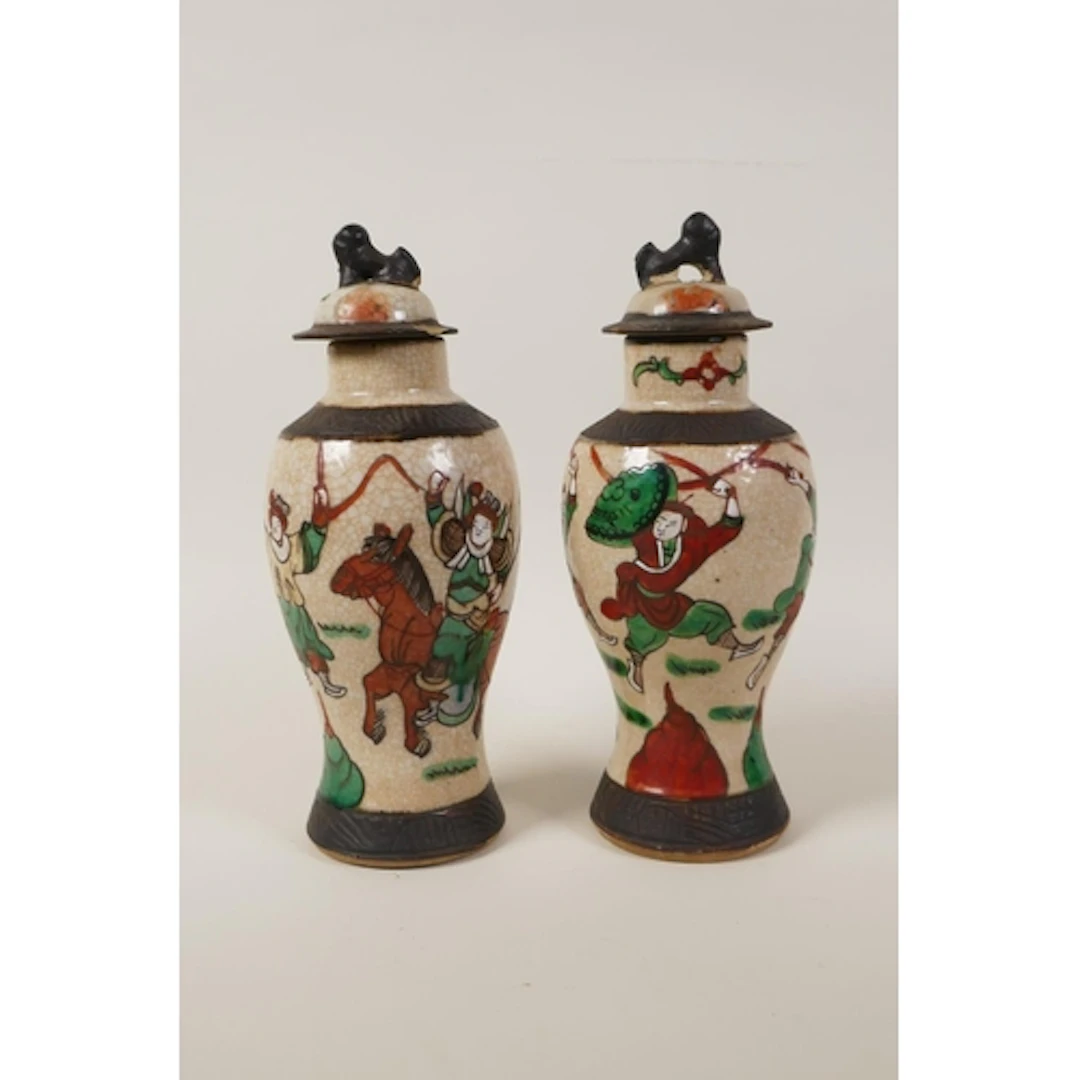 A pair of Chinese Nanking crackle ware jars and covers decor...