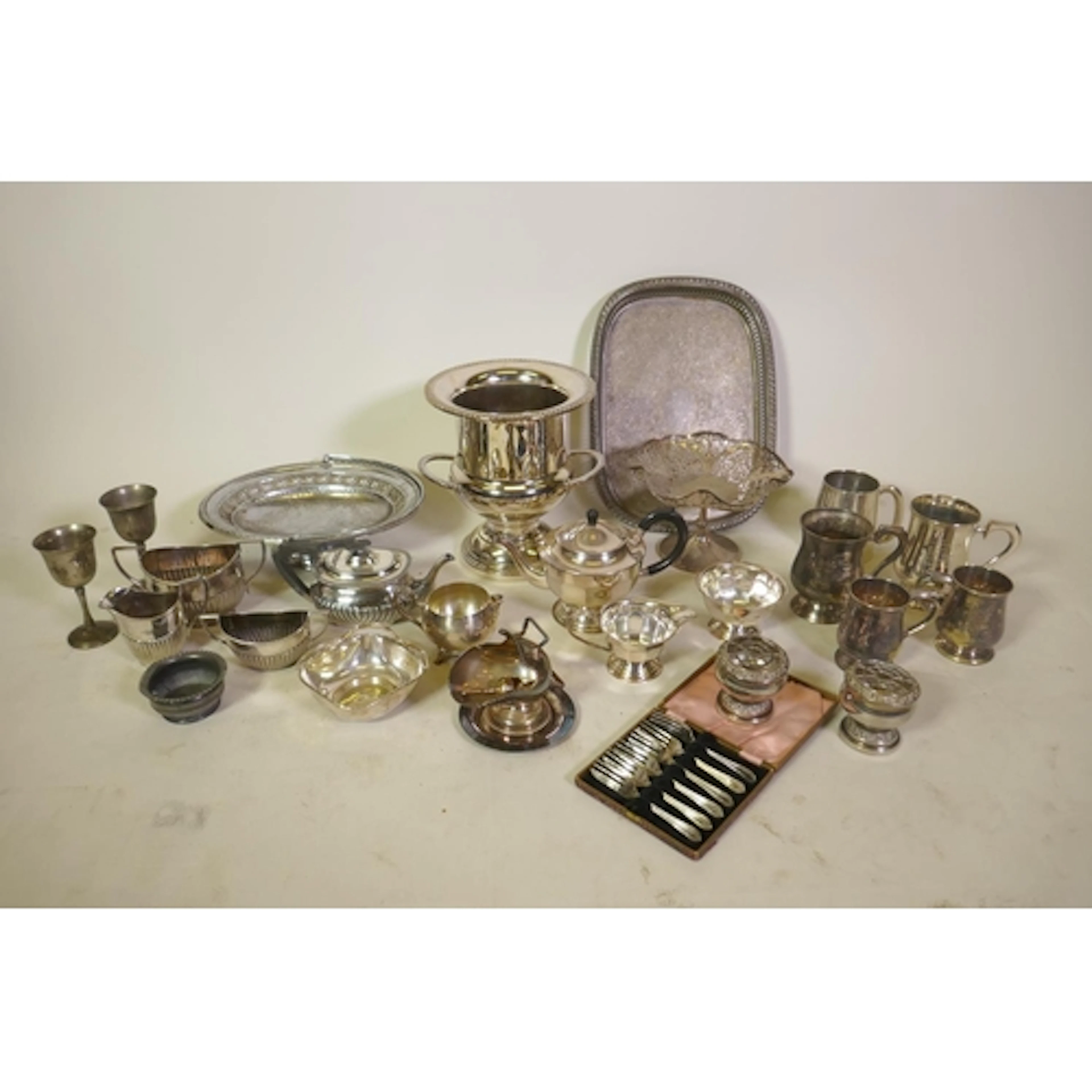 A large collection of silver plate to include a wine cooler,...