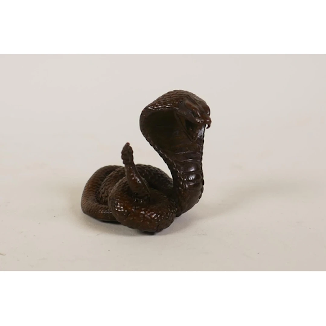 A miniature bronzed metal cobra, 5cm high