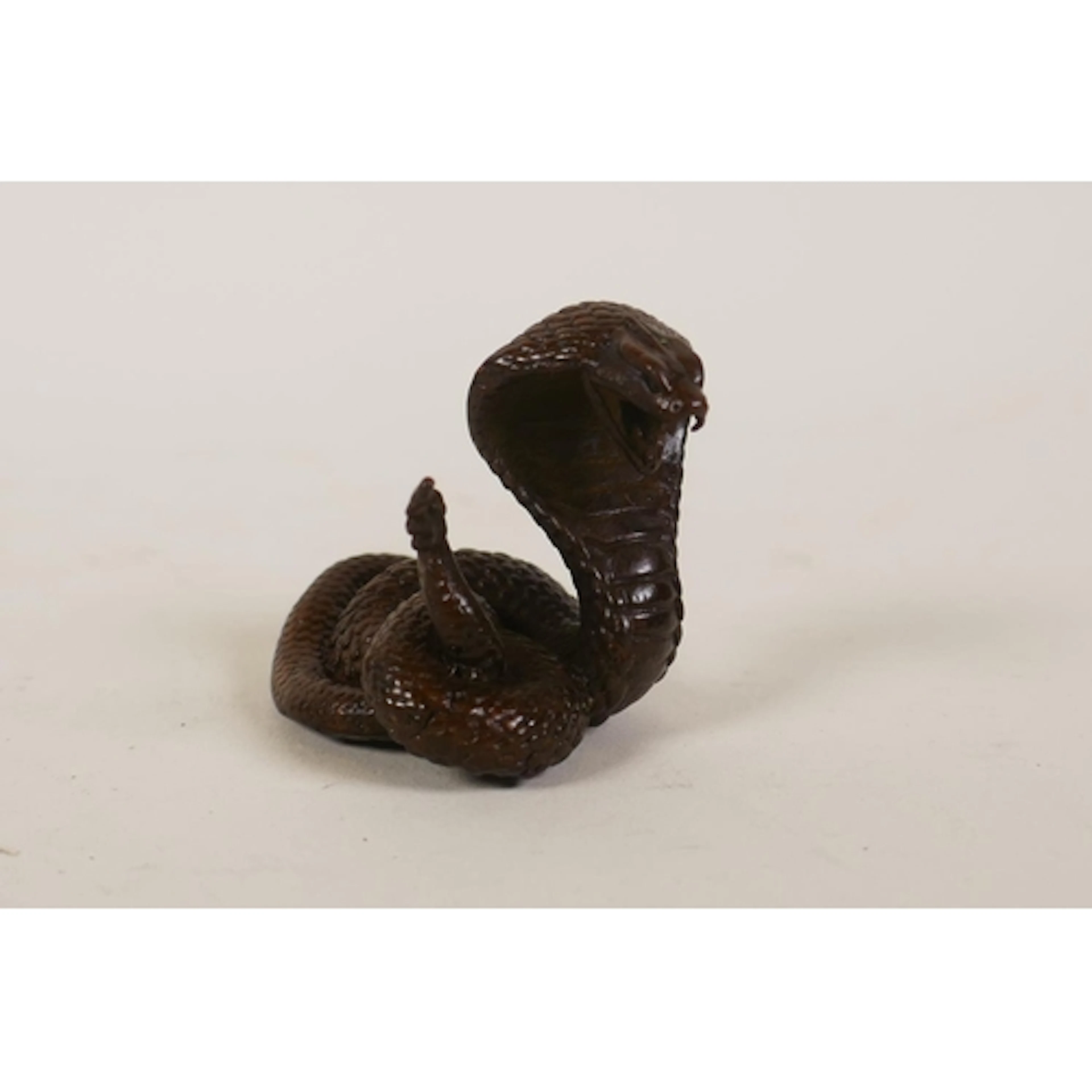 A miniature bronzed metal cobra, 5cm high