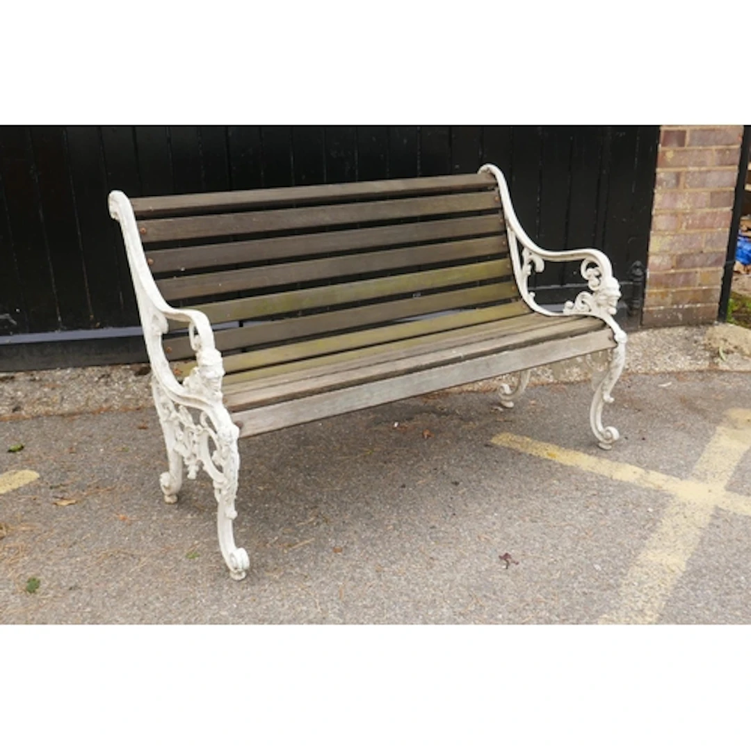 Victorian style painted metal garden bench with wooden slats...