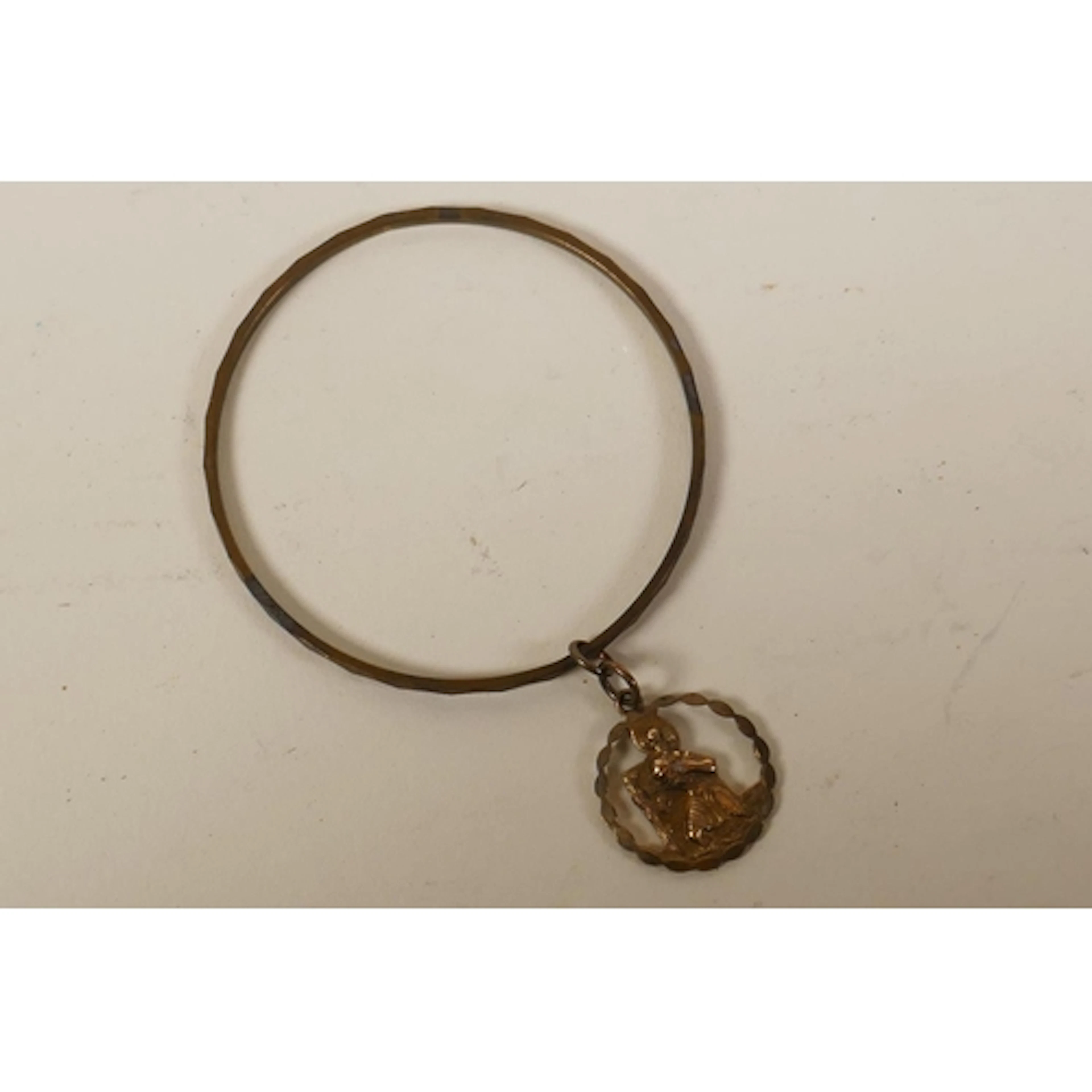 An 18ct gold bangle (7.8g approx) with attached 9ct gold St ...