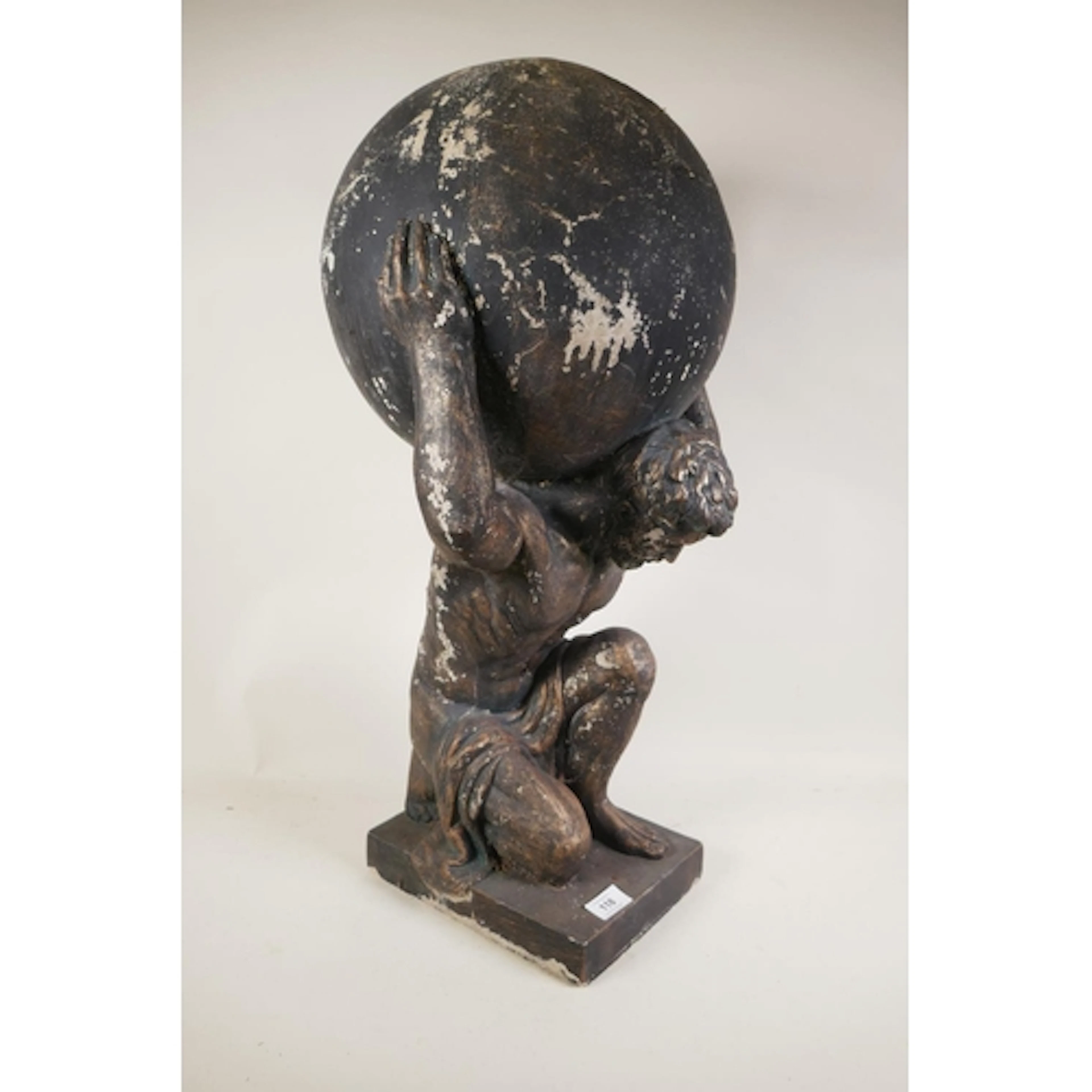 A vintage bronze painted plaster figure of Atlas holding the...