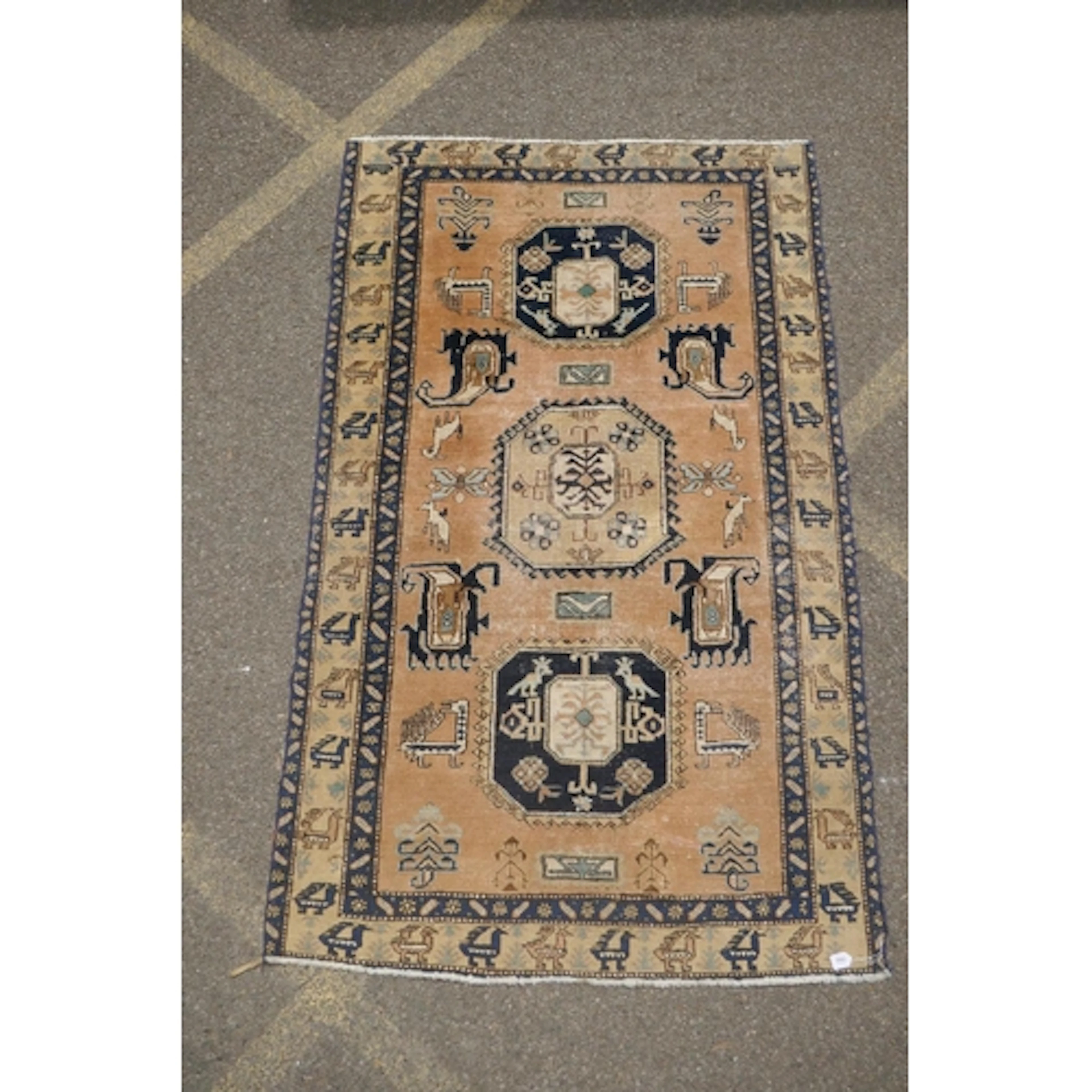 A vintage Persian Ardabil faded terracotta ground wool rug w...