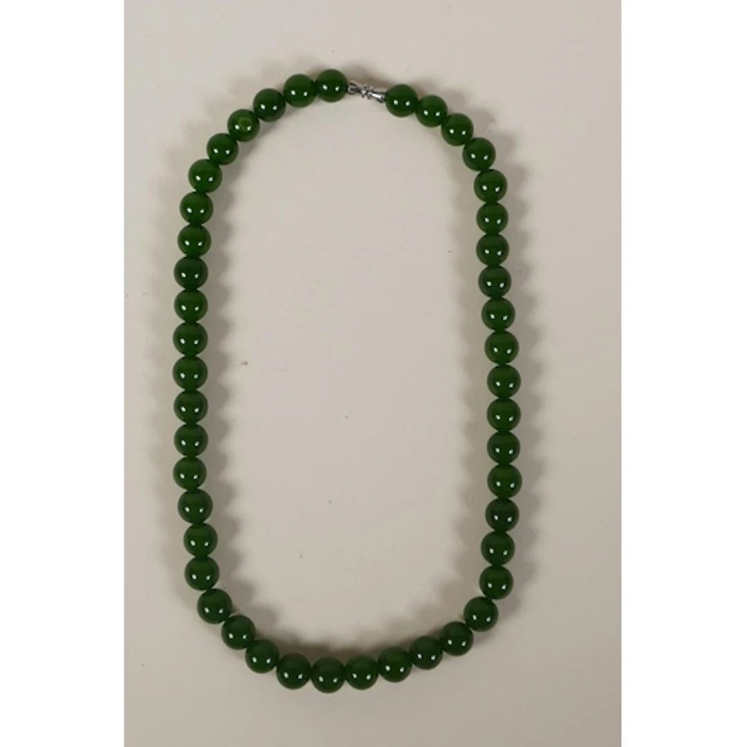 A Chinese apple jade beaded necklace, 42cm long