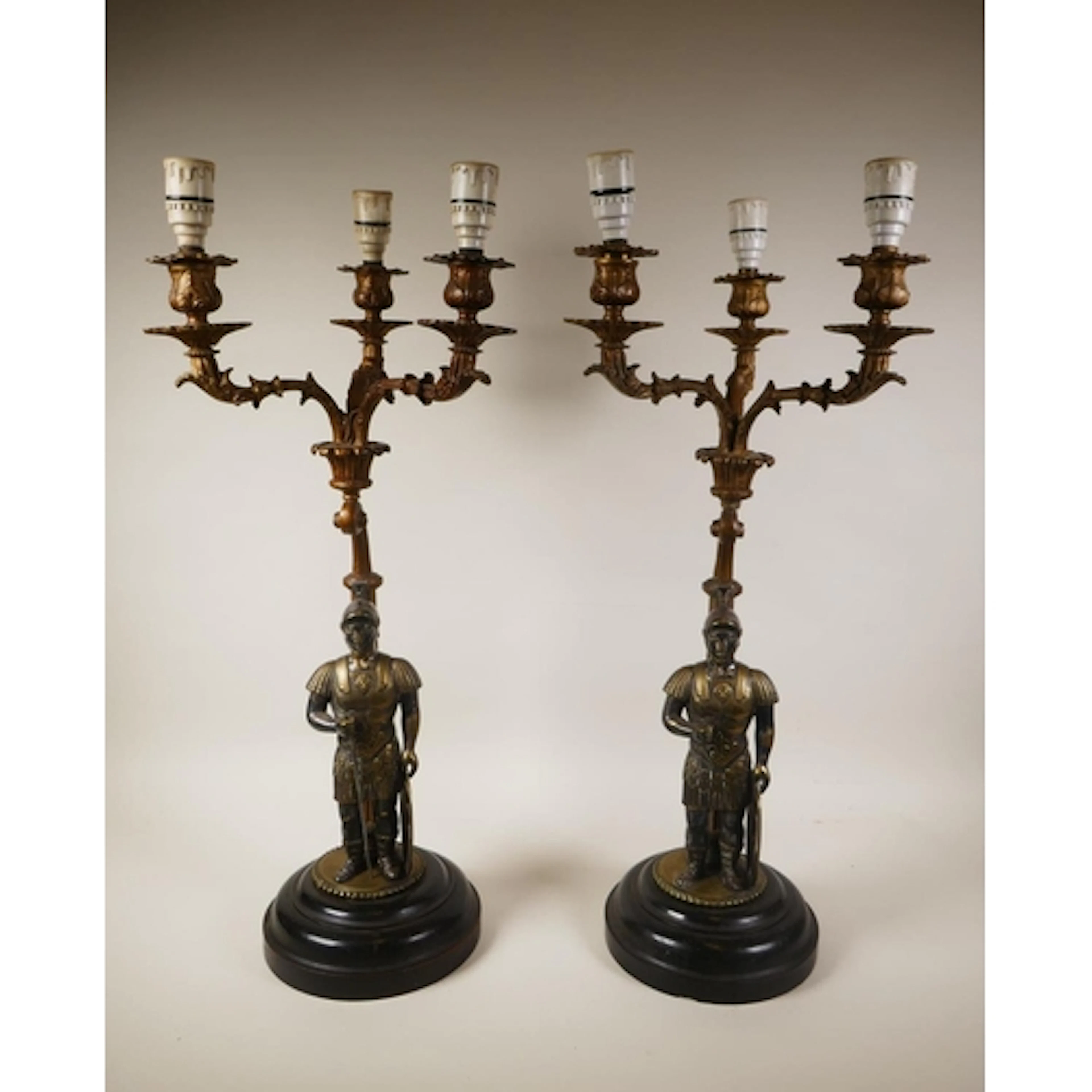 A pair of French empire style bronze three branch lamps deco...