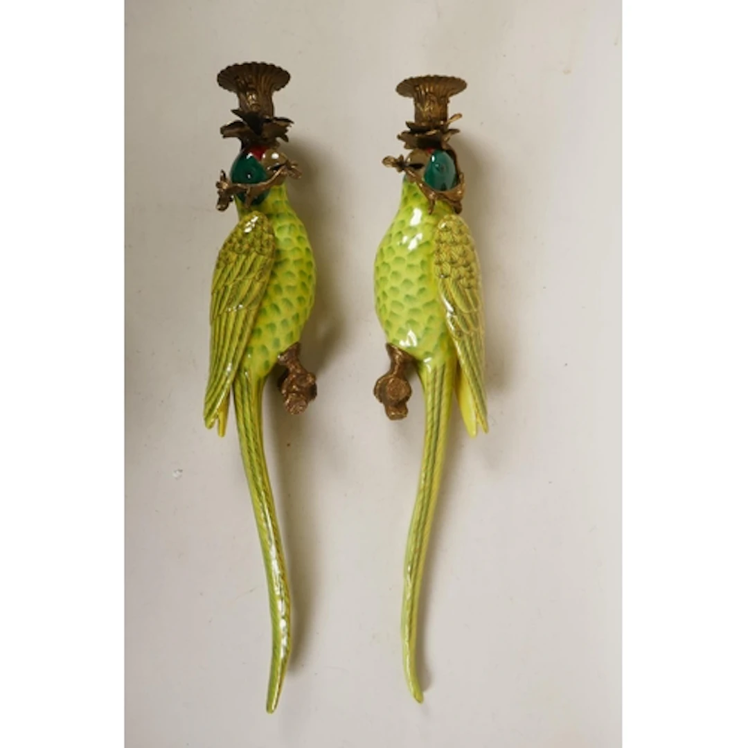 A pair of polychrome porcelain parrot wall sconces with gilt...