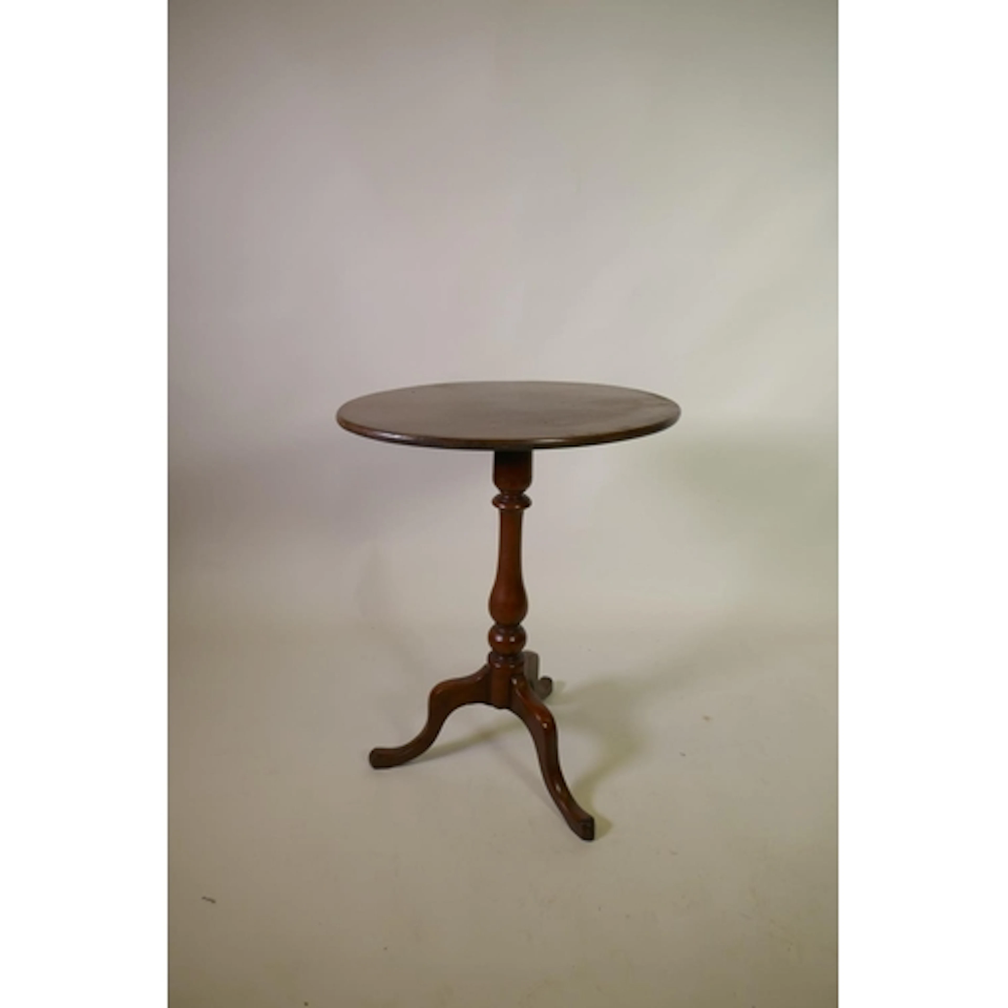 Early C19th mahogany tilt top wine table with oval top, rais...