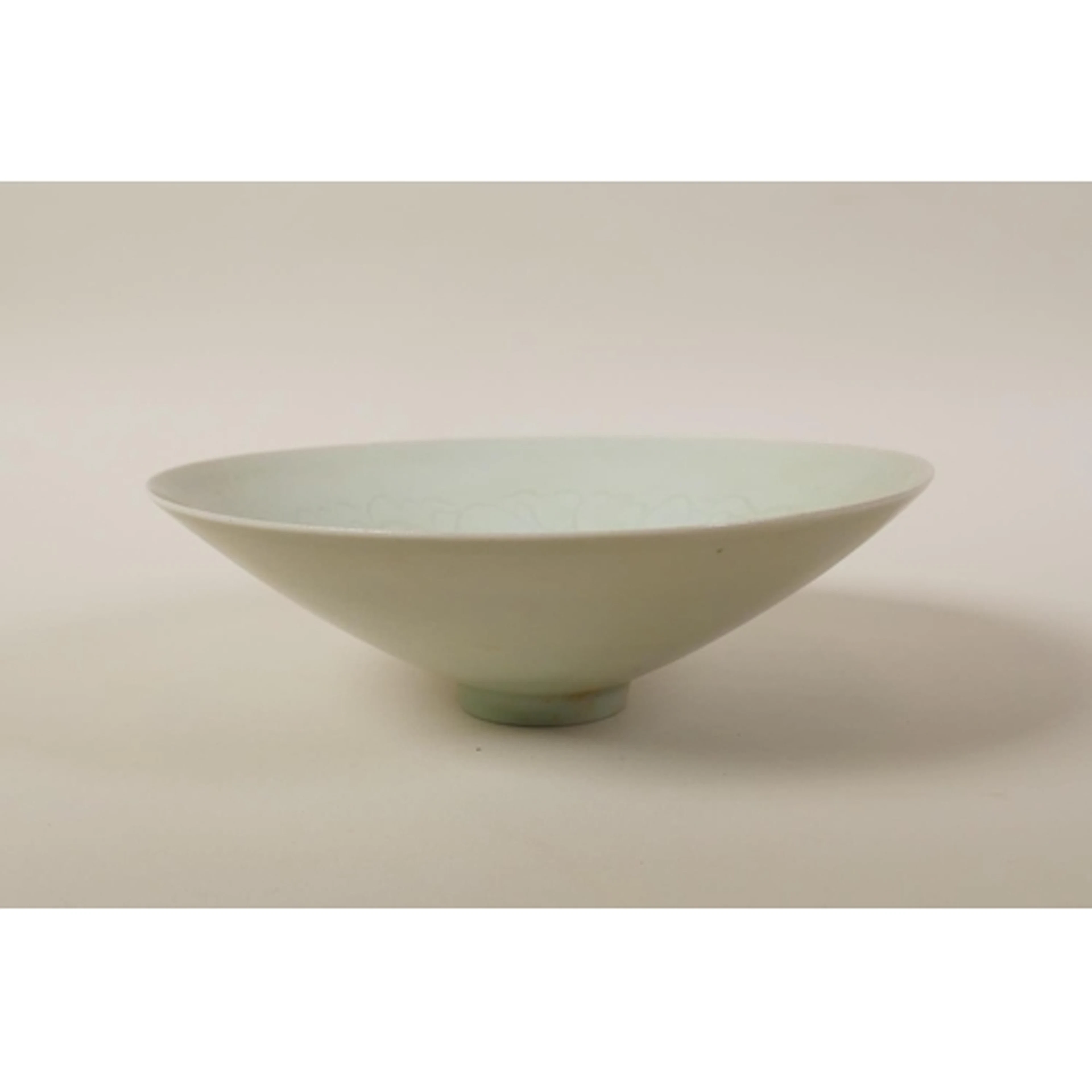 A Chinese celadon glazed porcelain bowl of conical form, wit...