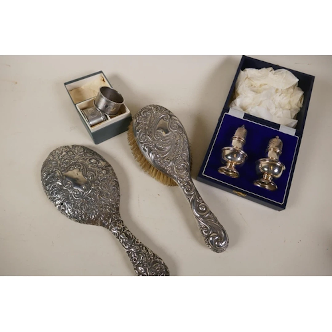 A Victorian silver hairbrush with repousse decoration and Vi...