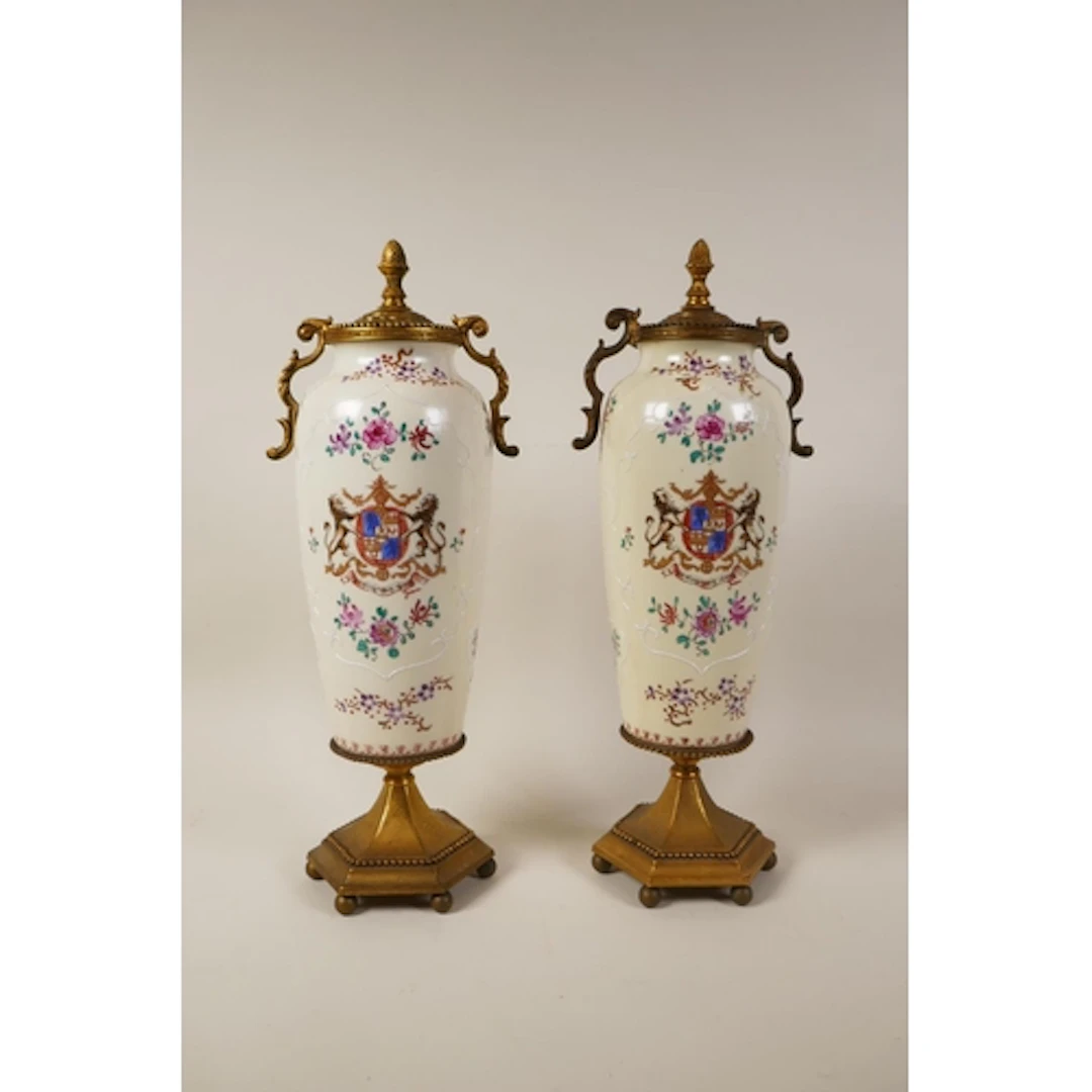 A pair of gilt metal mounted porcelain vases decorated with ...
