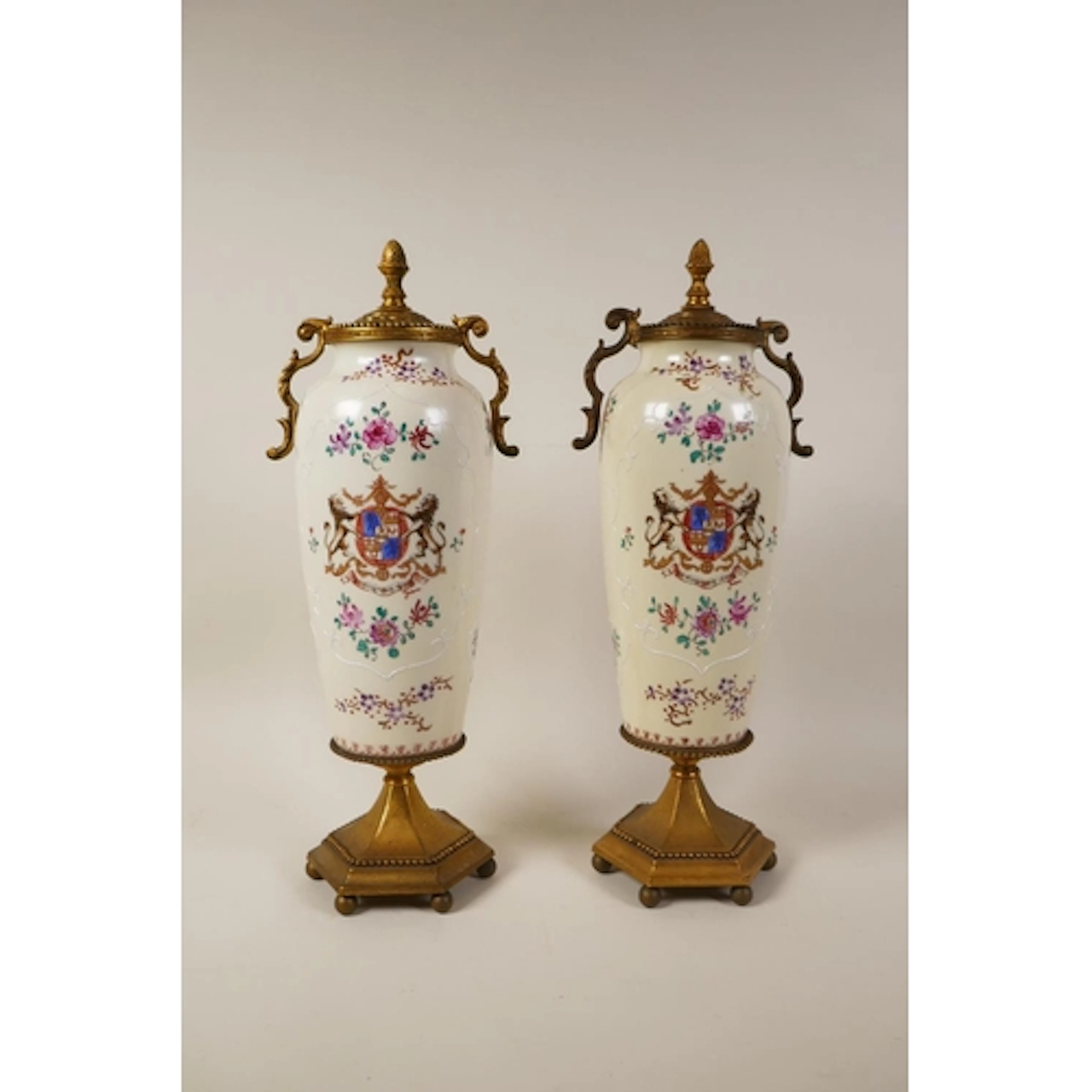 A pair of gilt metal mounted porcelain vases decorated with ...