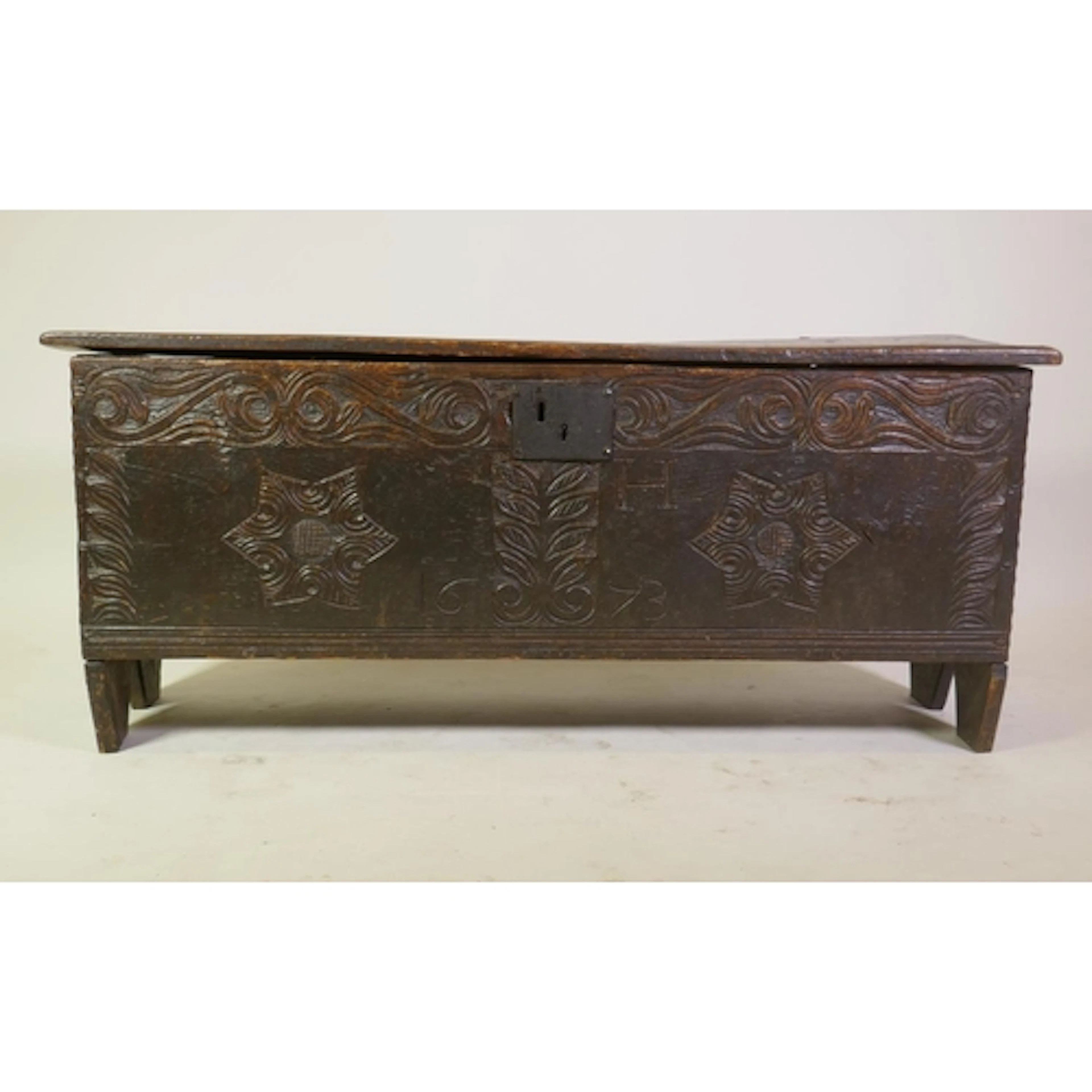 A C17th Carolean Charles II six plank coffer with carved fro...