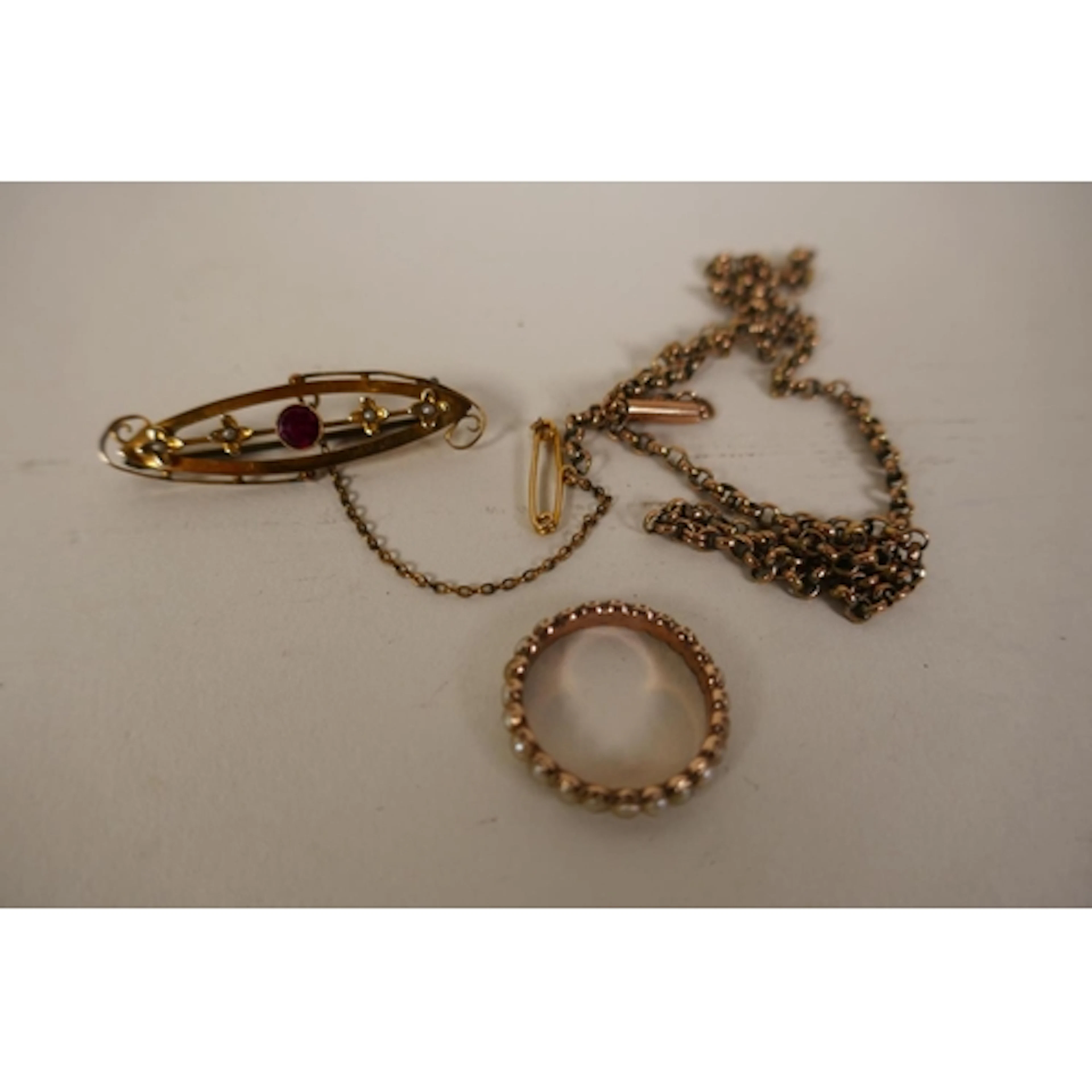 An antique yellow metal eternity ring set with seed pearls (...