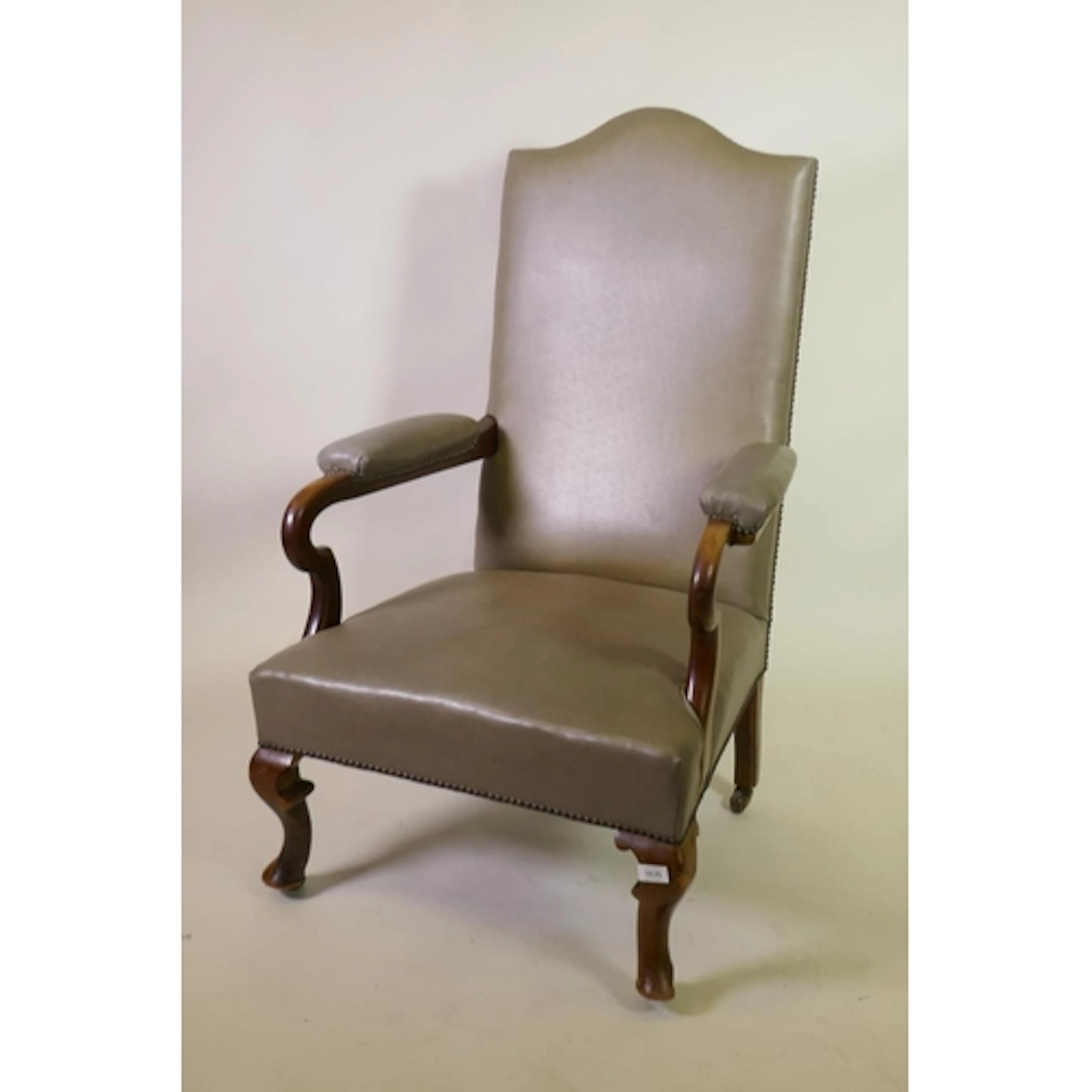 A walnut open arm library chair with leather upholstery and ...