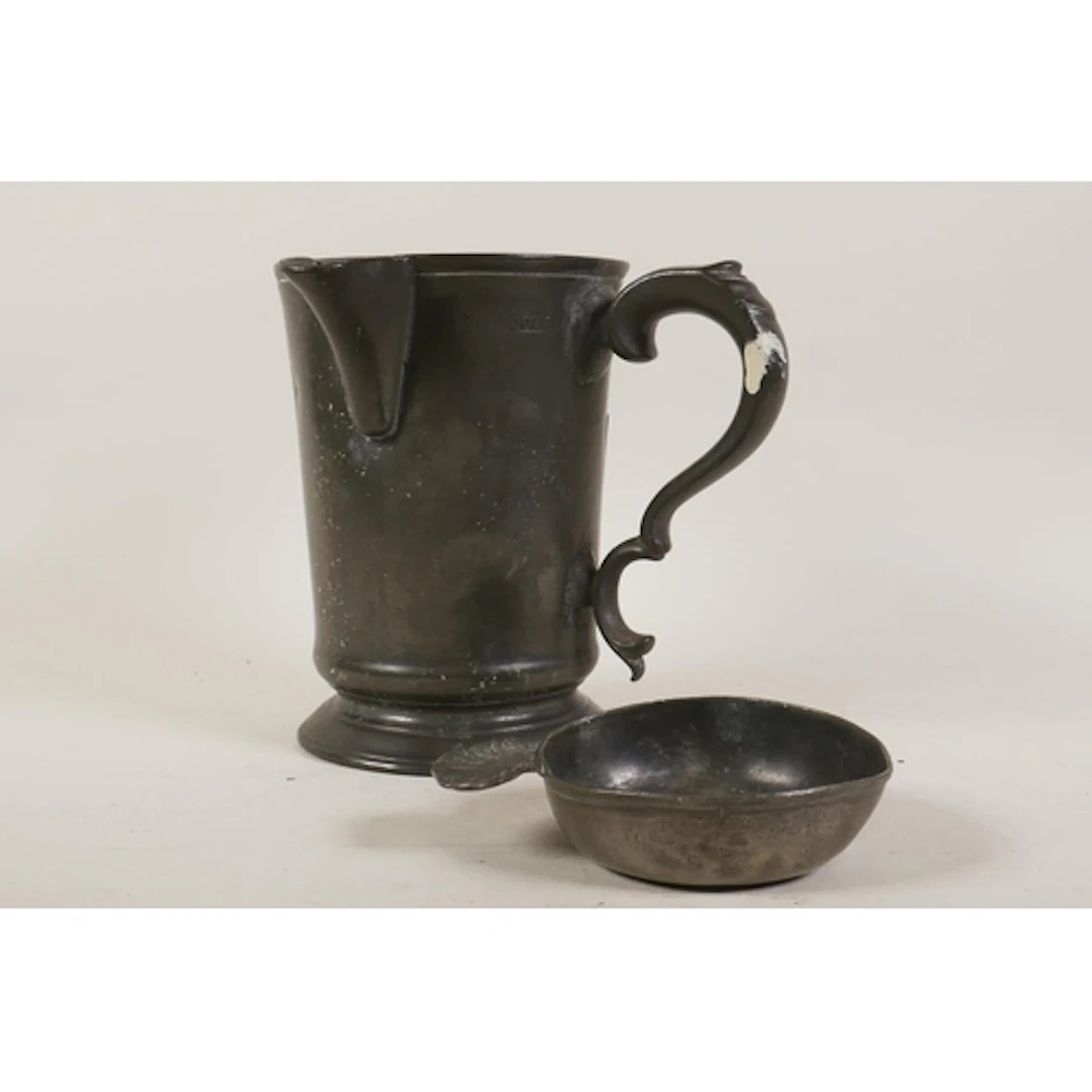 A Victorian pewter quart jug, inscribed to base James - Wago...