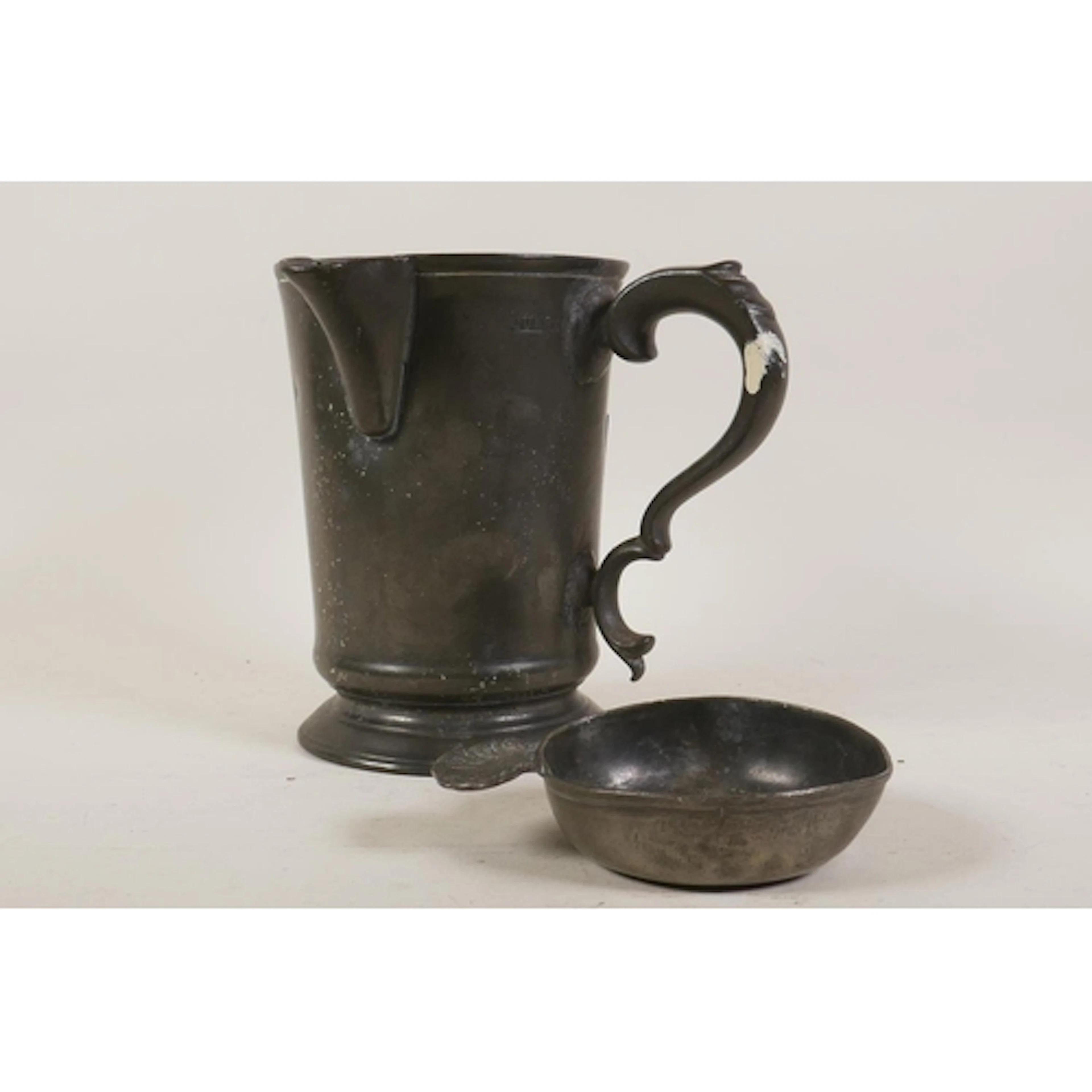 A Victorian pewter quart jug, inscribed to base James - Wago...