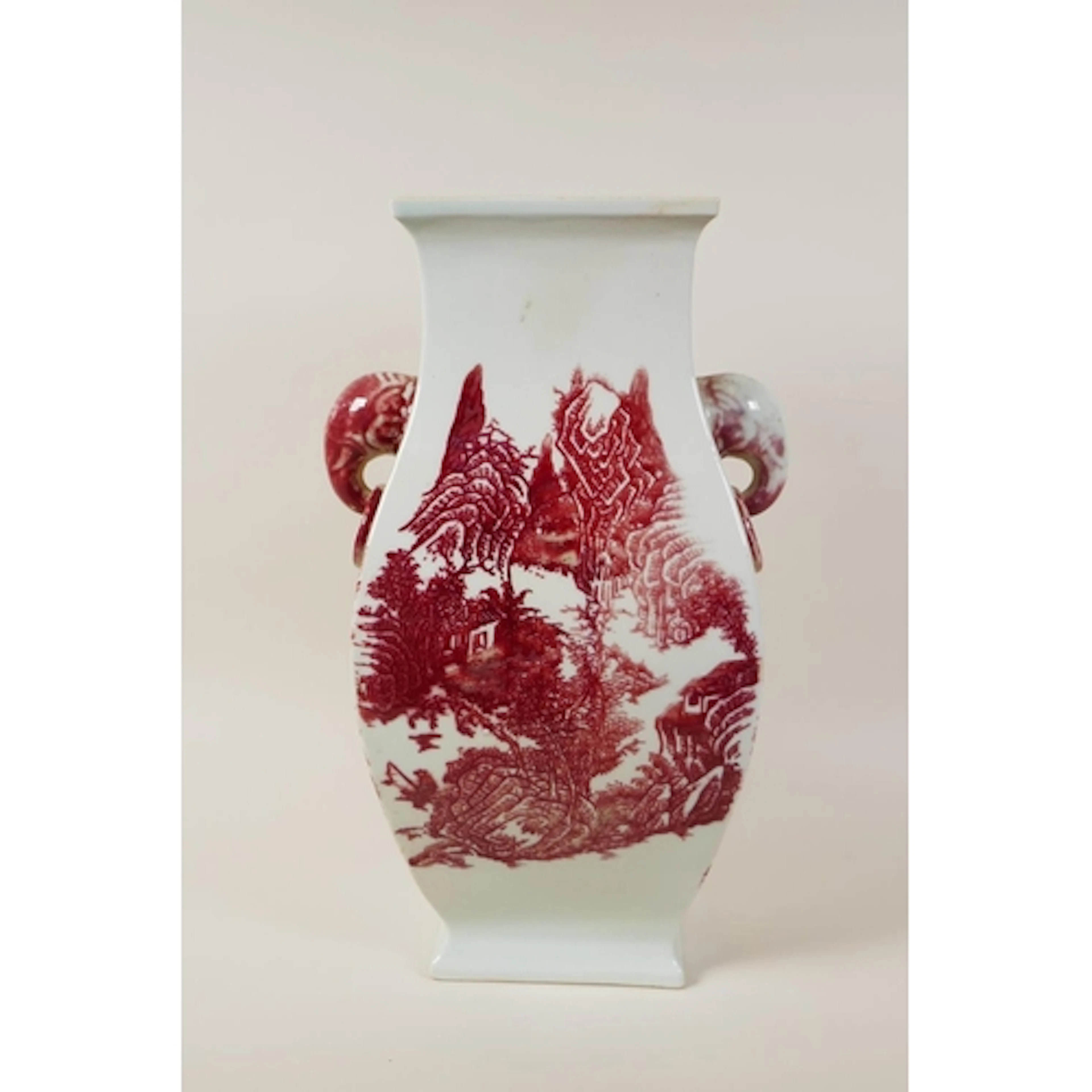 A Chinese red and white porcelain vase with elephant head ha...