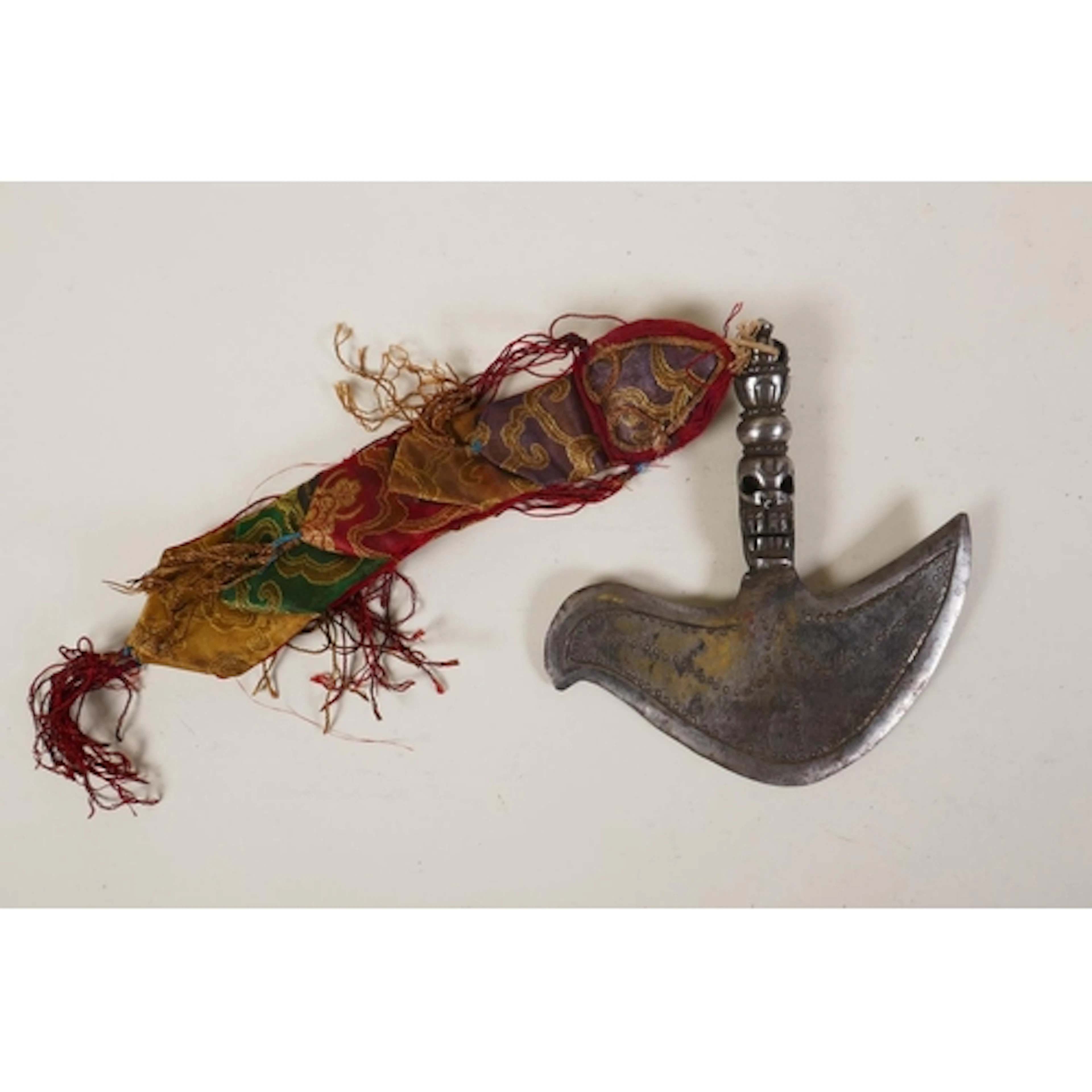 A Tibetan ceremonial iron kartika with mask decoration to th...