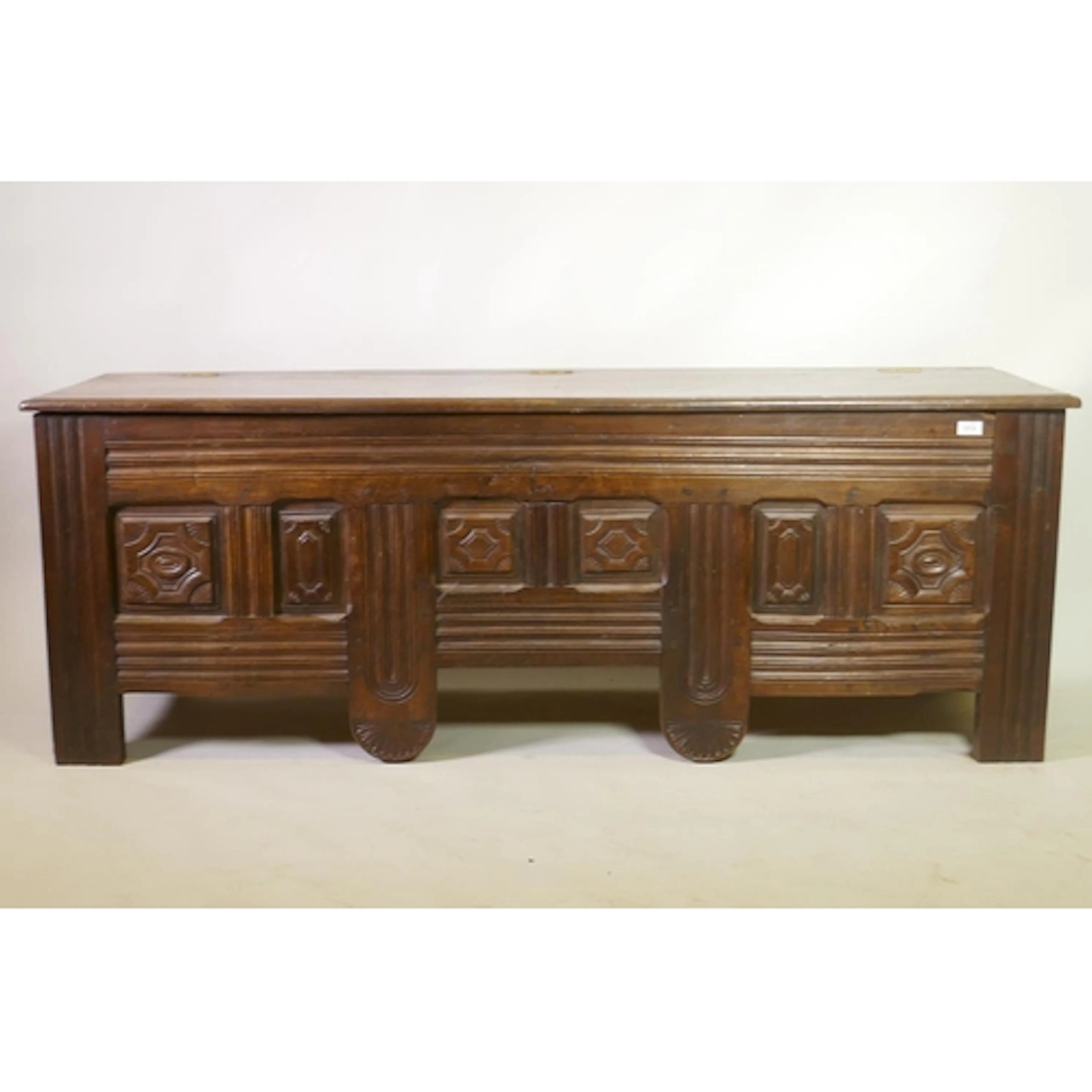An C18th/C19th French oak coffer with carved panels to front...