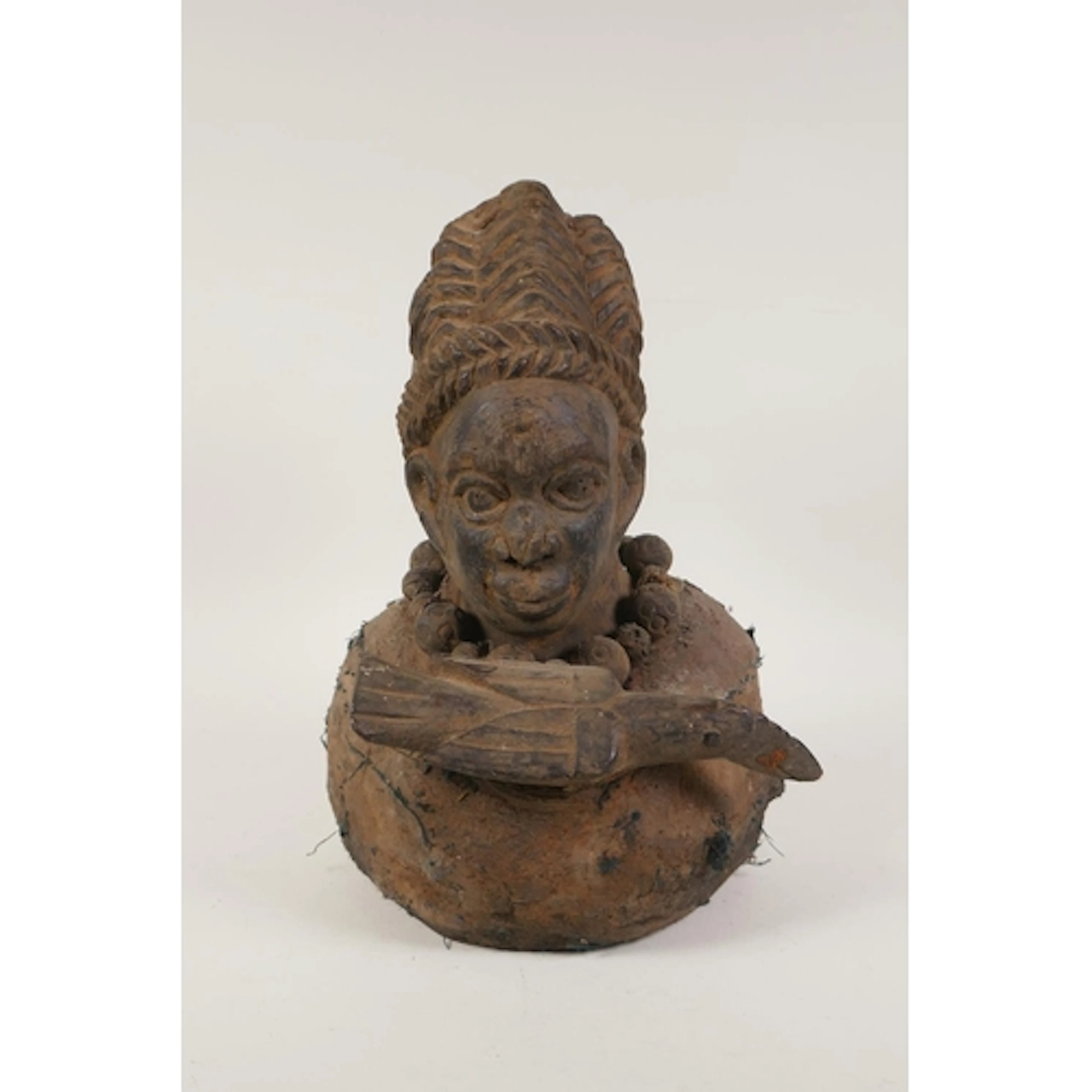 A West African carved wood tribal fetish head bust with a bi...