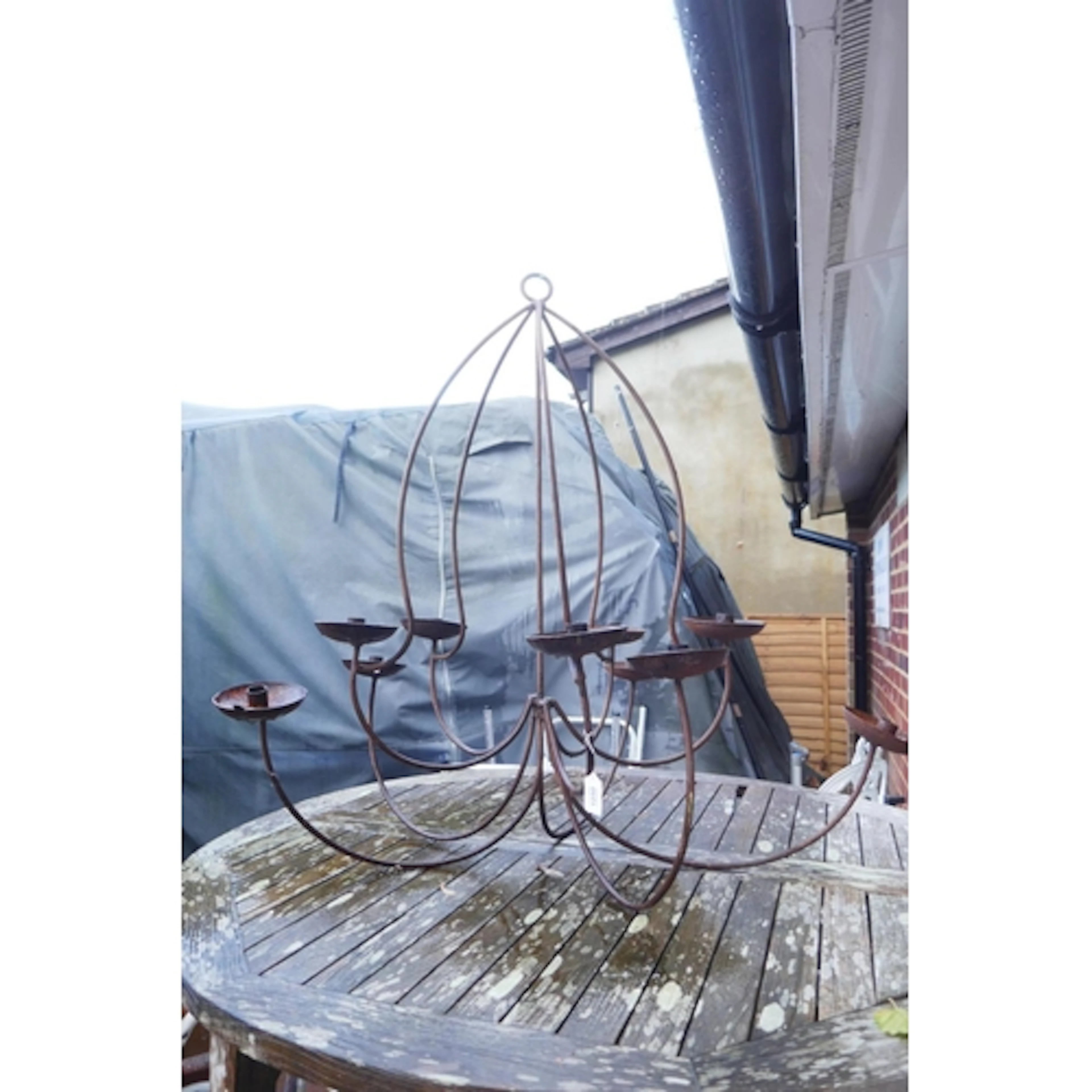 A wrought iron ten branch candle chandelier, 85cm drop