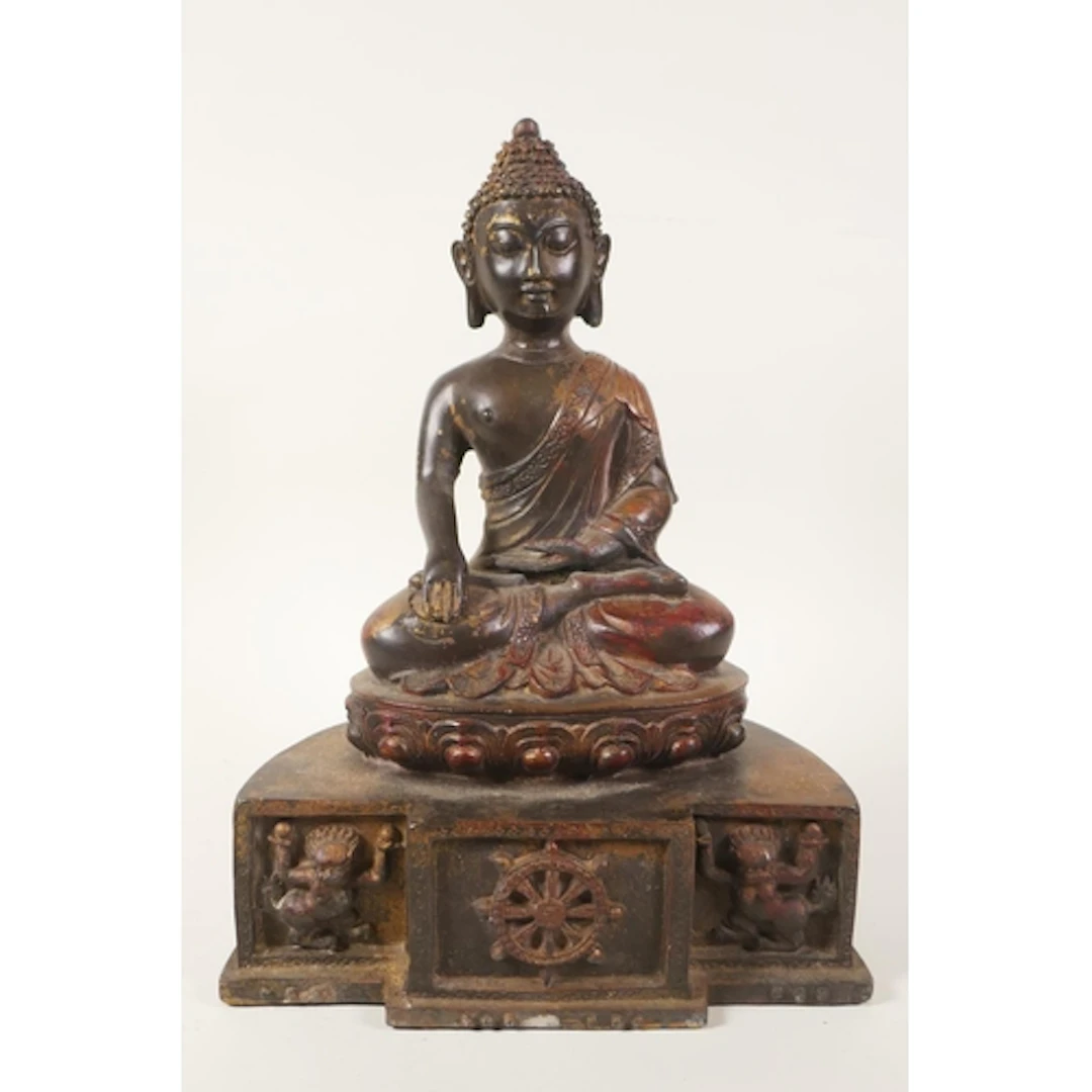 A Tibetan bronze figure of Buddha seated on a lotus throne, ...