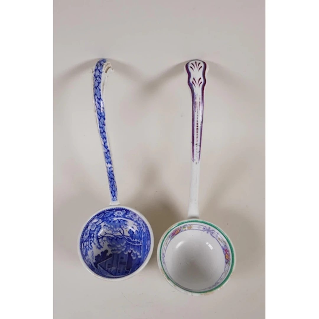 An antique blue and white transfer printed pottery ladle and...