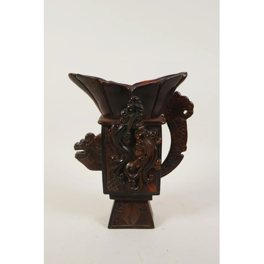 A Chinese sectional horn libation cup of archaic form, with ...