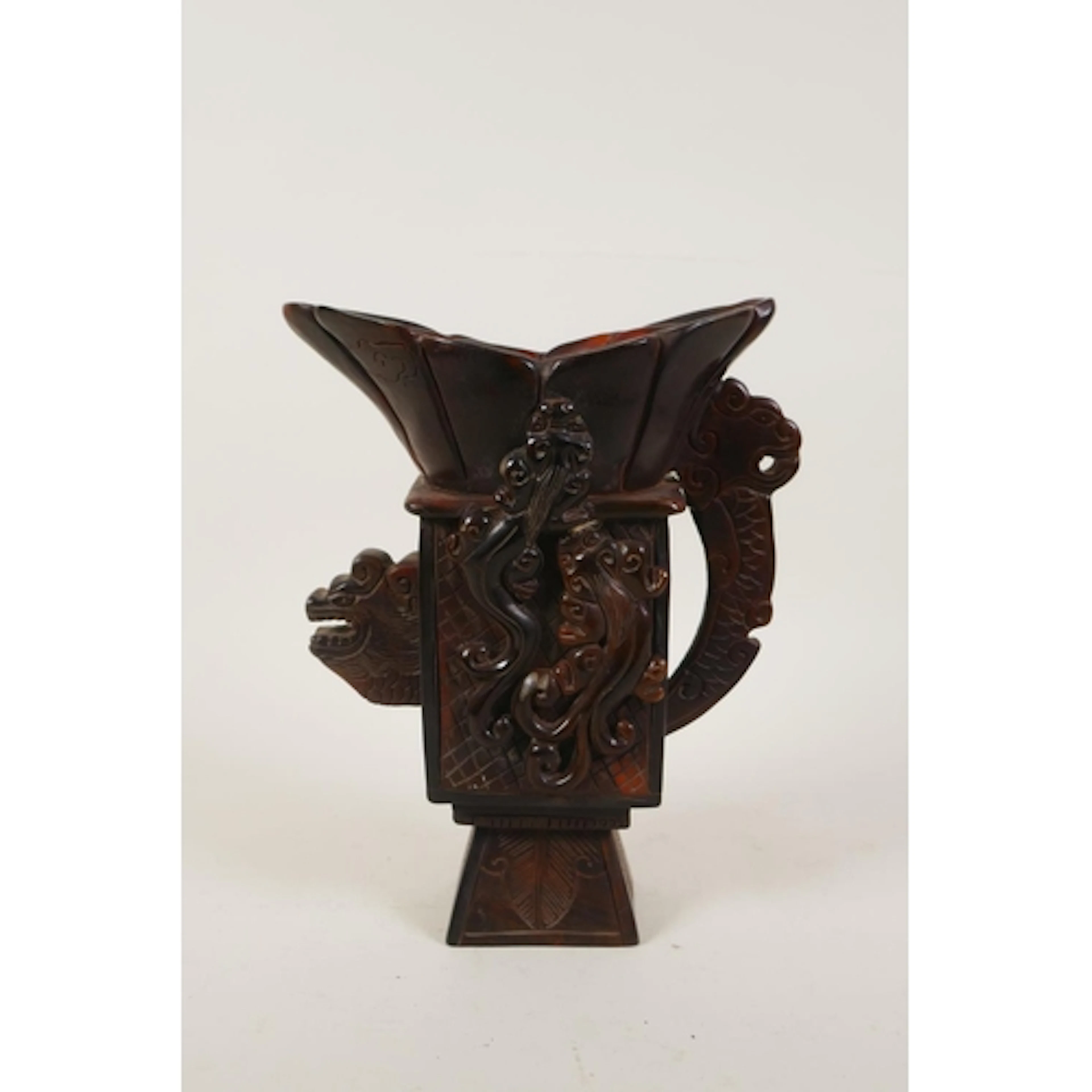 A Chinese sectional horn libation cup of archaic form, with ...