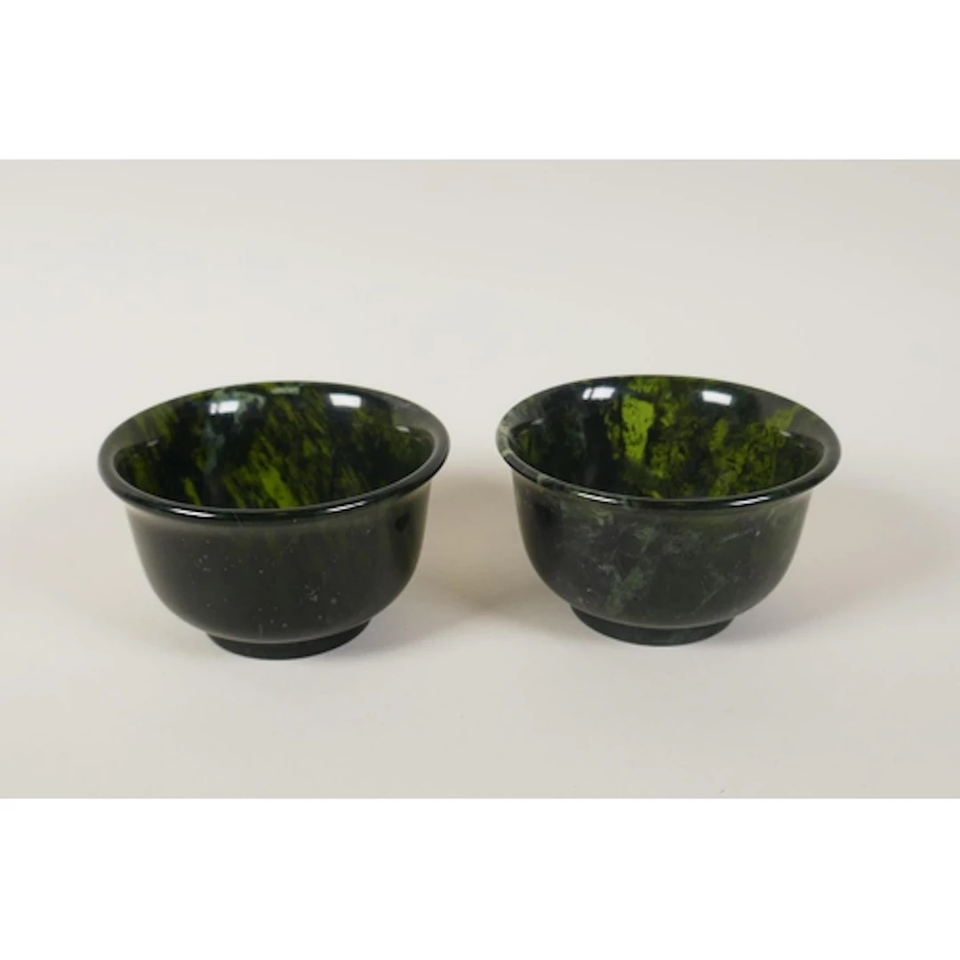 A pair of spinach jade tea bowls, 7.5cm diameter