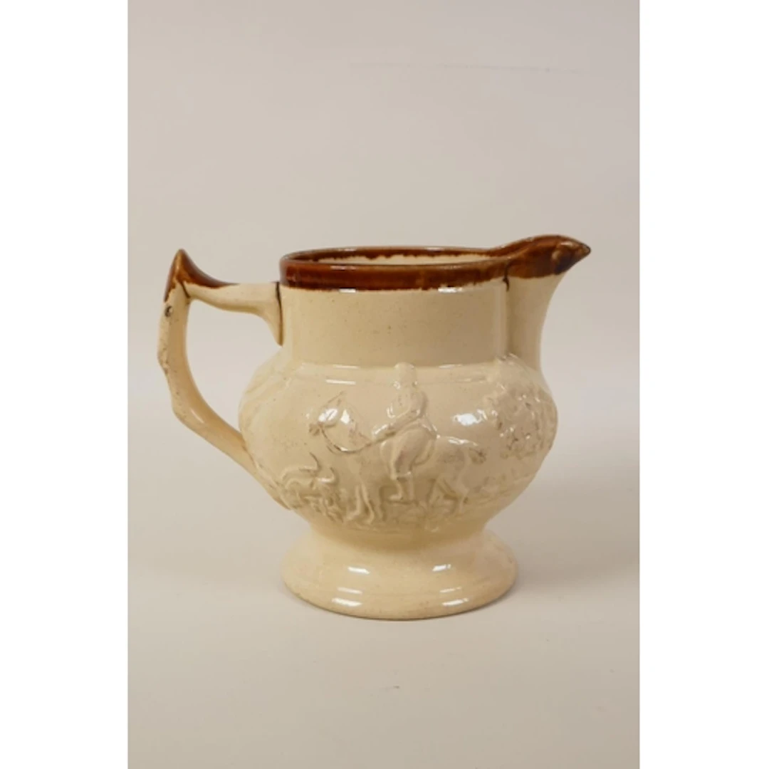 A C19th salt glaze imperial quart jug with raised hunting sc...