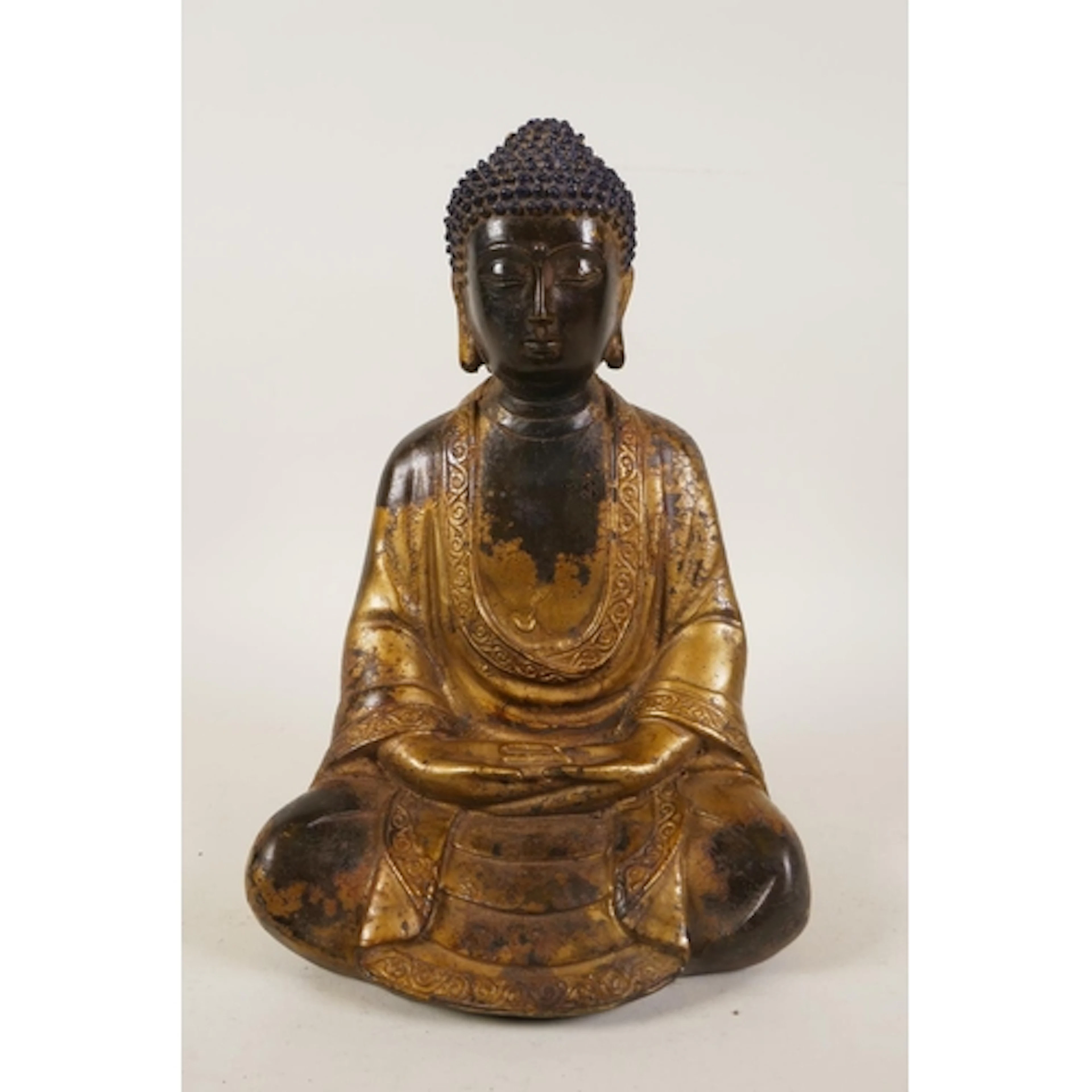 A Sino Tibetan gilt bronze figure of Buddha, 23cm high